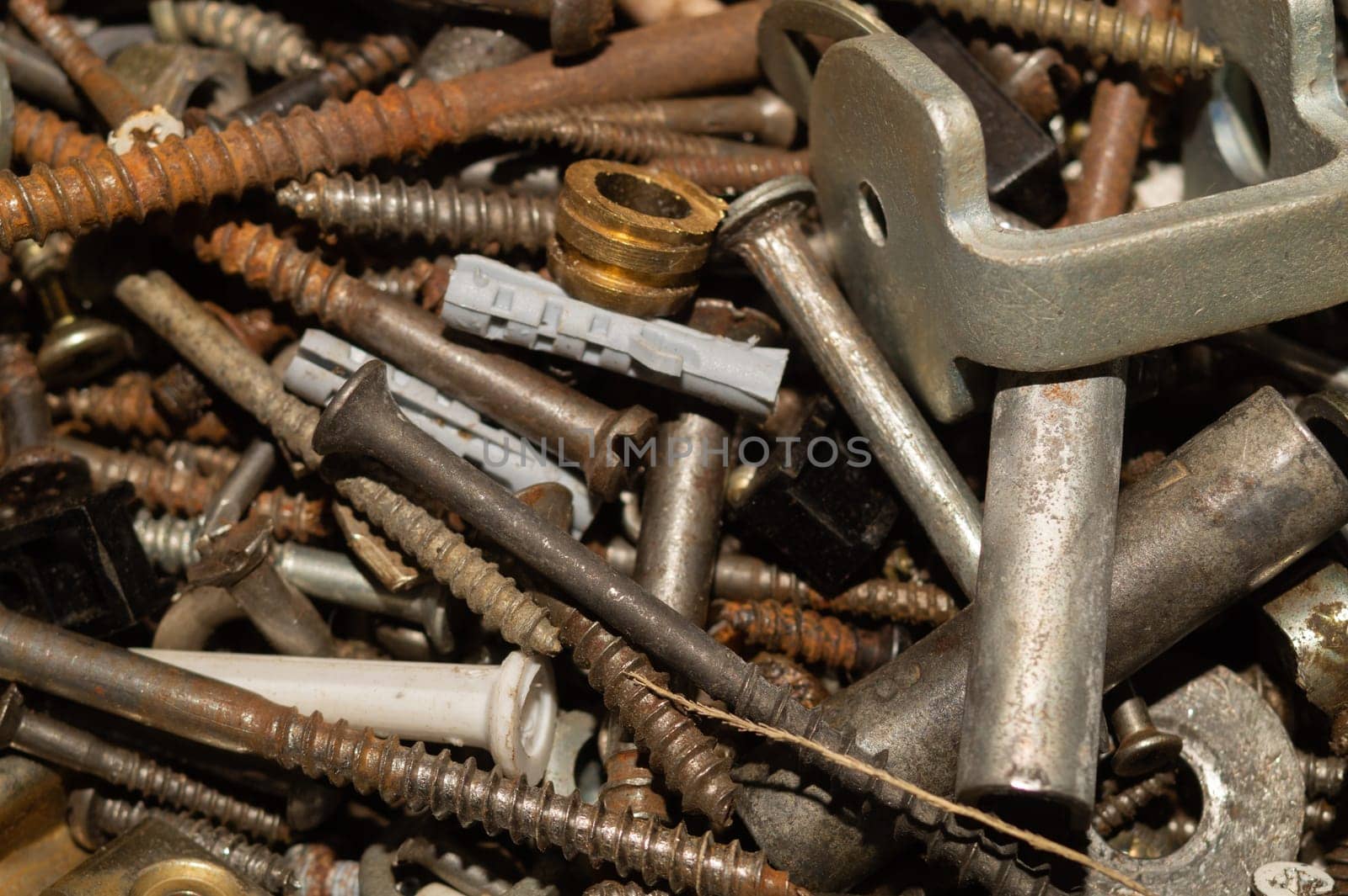 Old screws background. heap of tapping screws. work tool. pile of fasteners. bolts and nuts. metal scrap