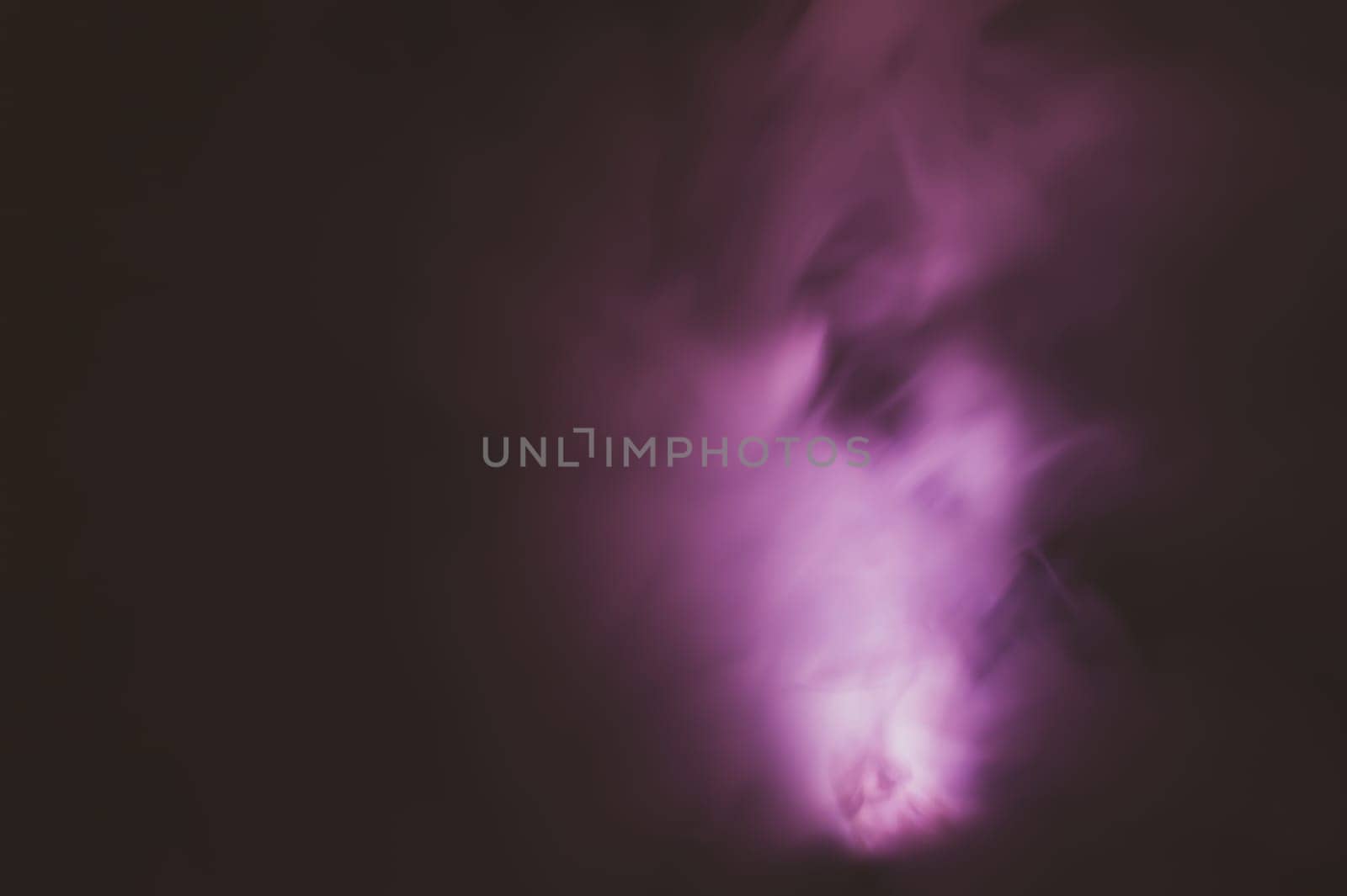 Violet smoke on black backdrop. color fog abstract background