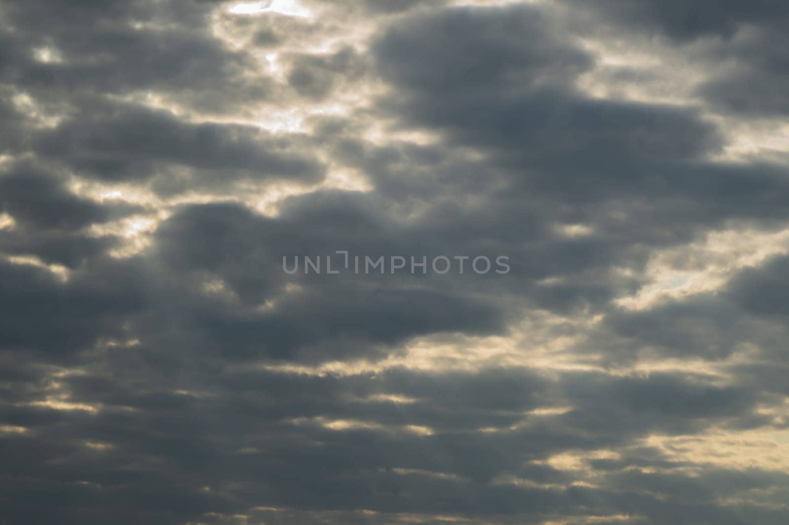 Sunlight shines through the cloudy sky. stormy sky with sunbeam. overcast weather