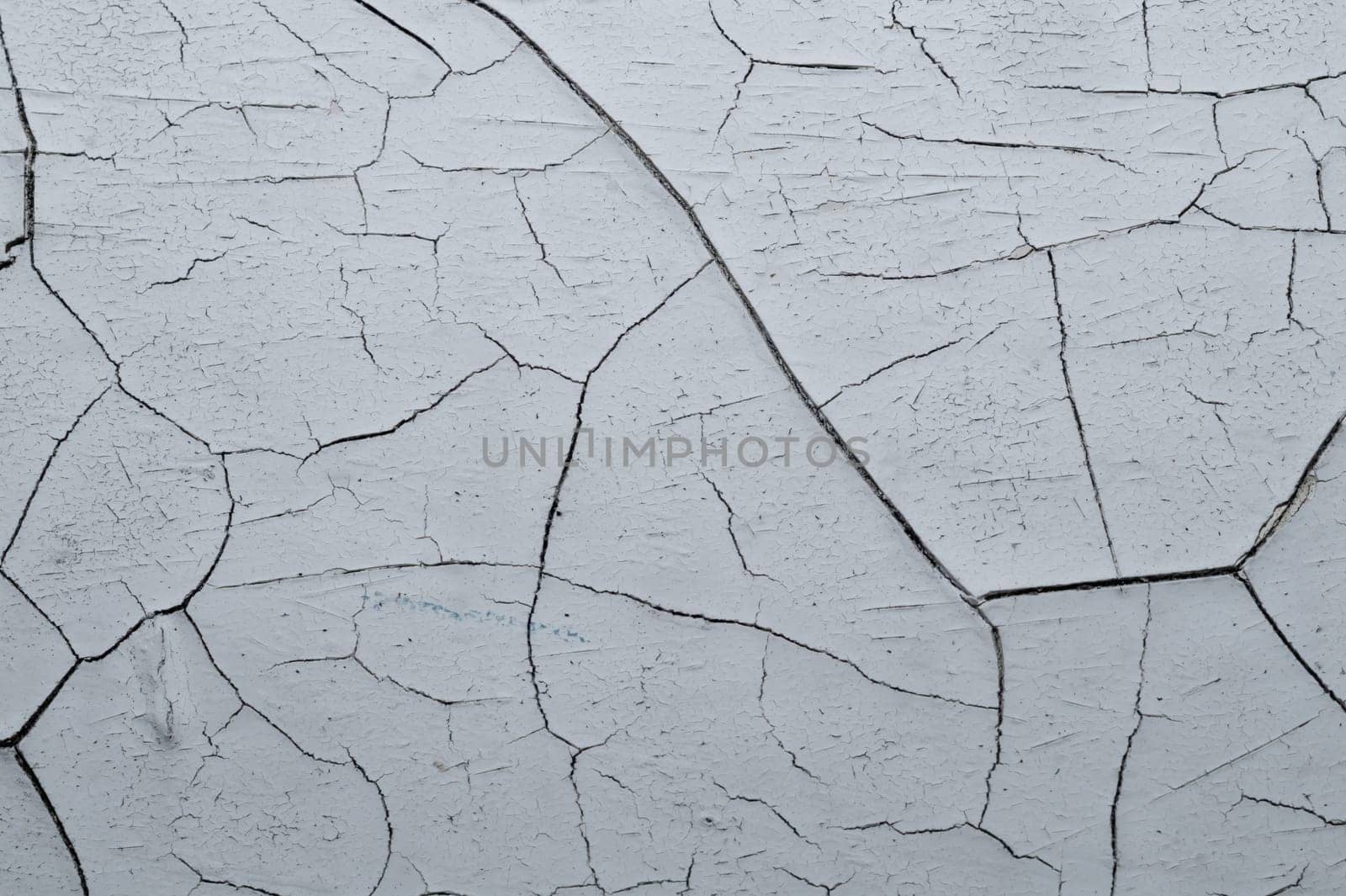 Cracked paint on a wooden surface. grunge texture with peeling paint on wood