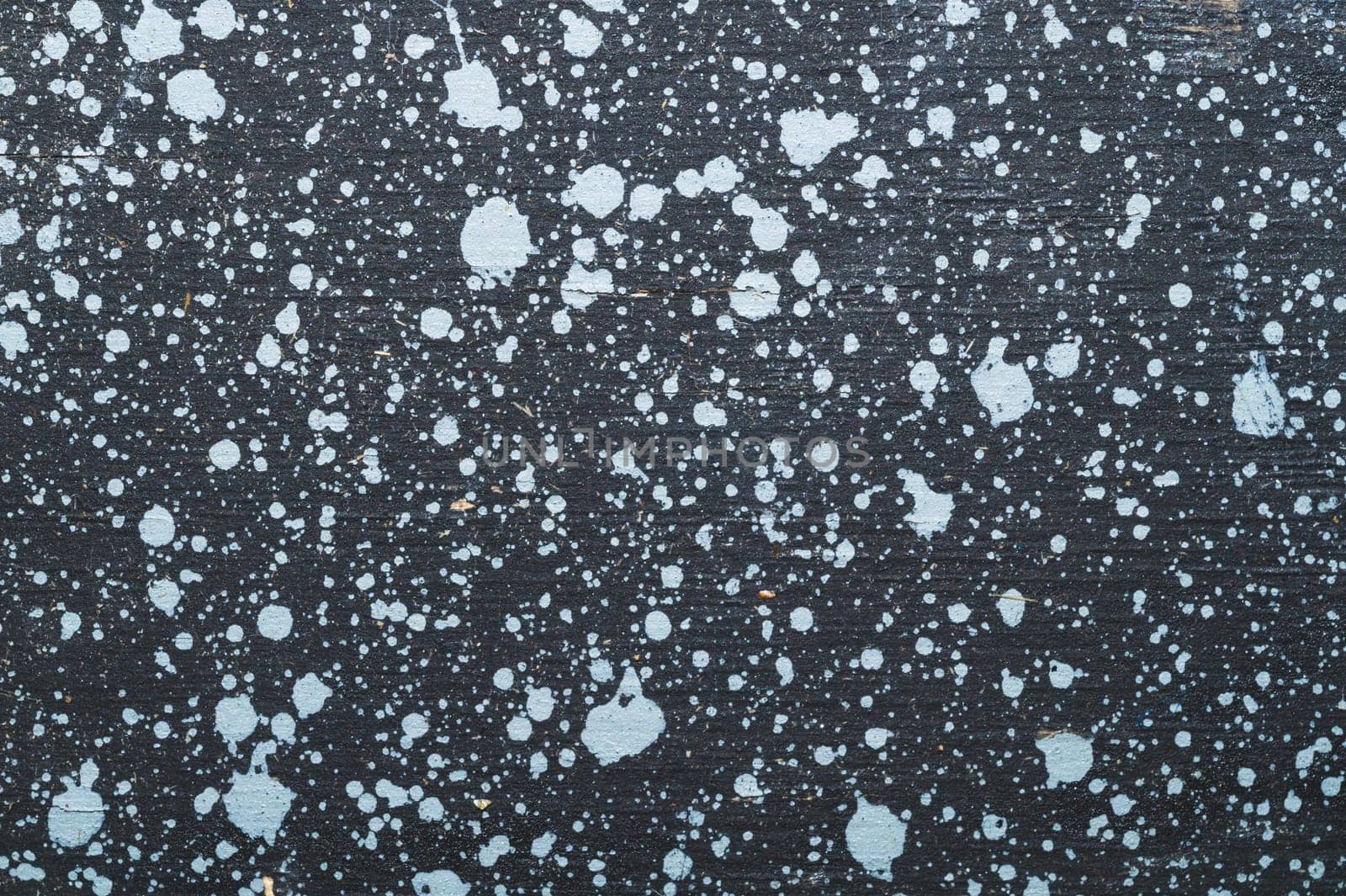 Painted wood surface with spots. wooden background with paint splashes. grunge texture with stains and scratches