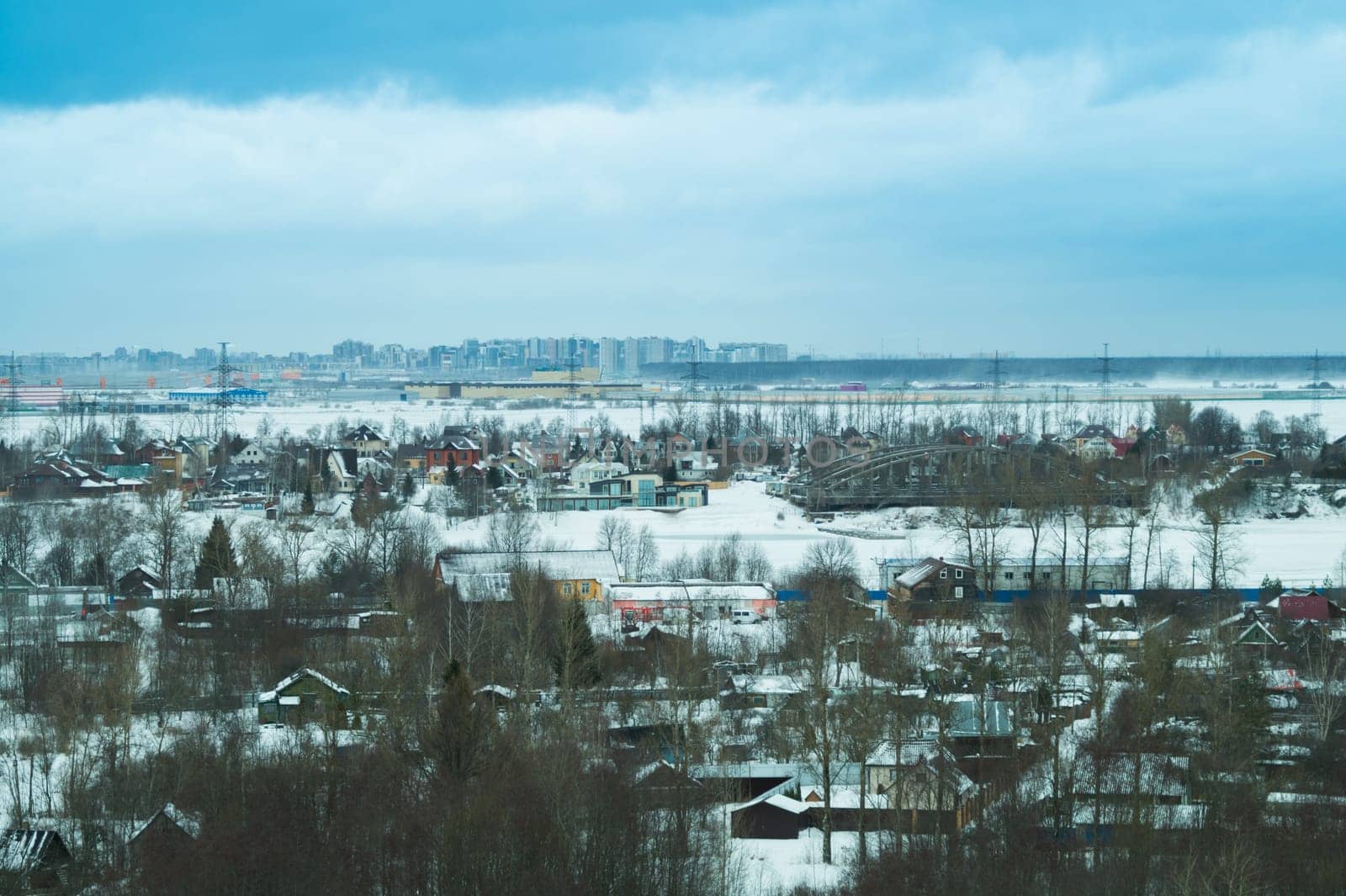 Snow covered houses with the gardens in winter. wooden houses in the forest aerial view. rural landscape from high view