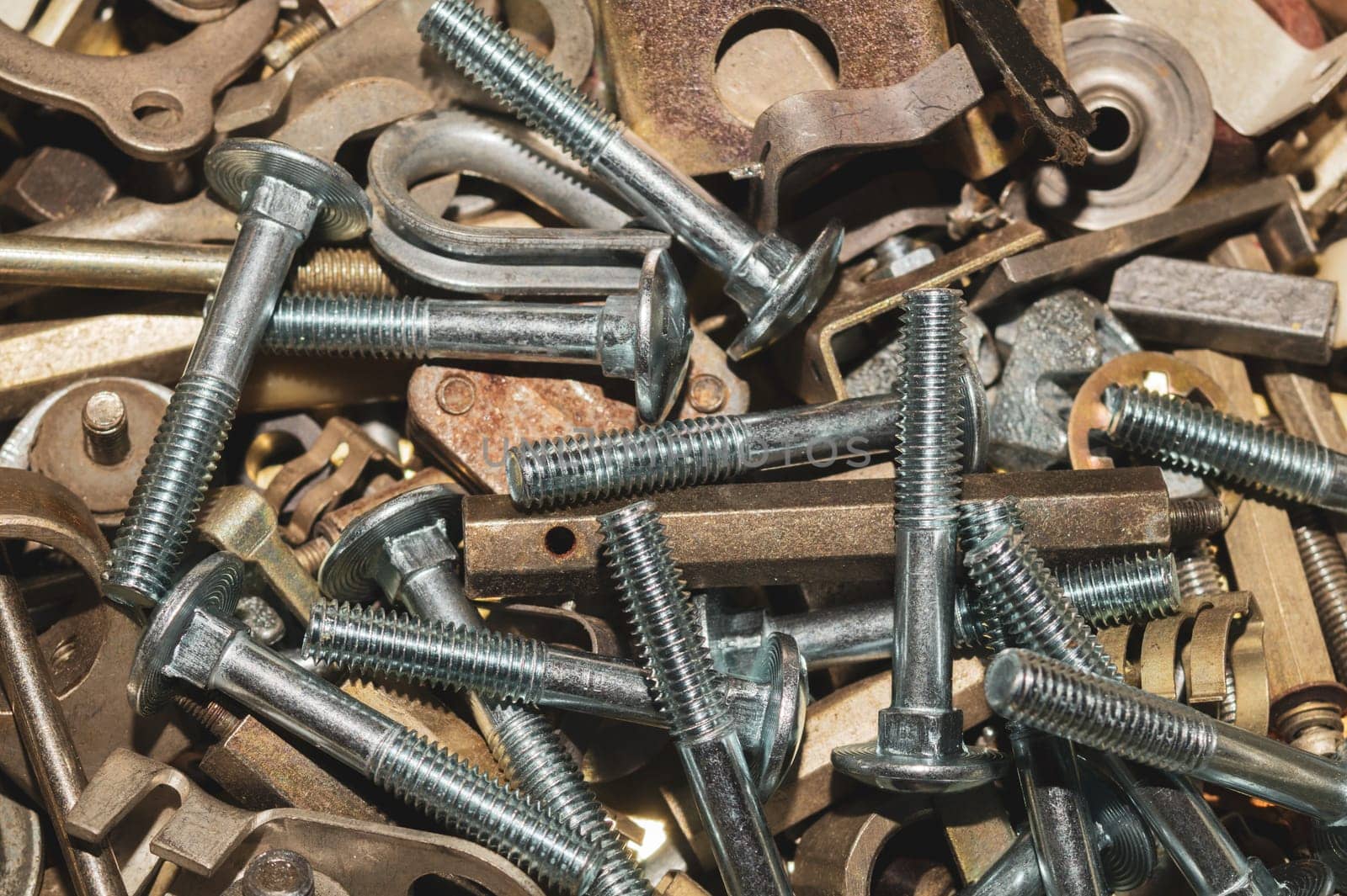 Old screws background. heap of tapping screws. work tool. pile of fasteners. bolts and nuts. metal scrap