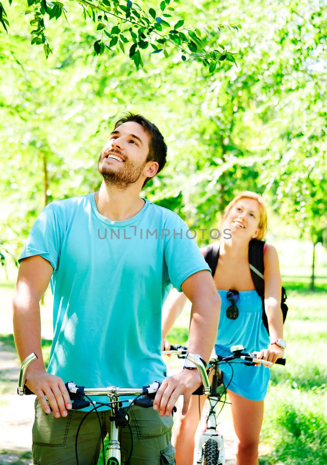 Young man and woman having a bike ride in nature