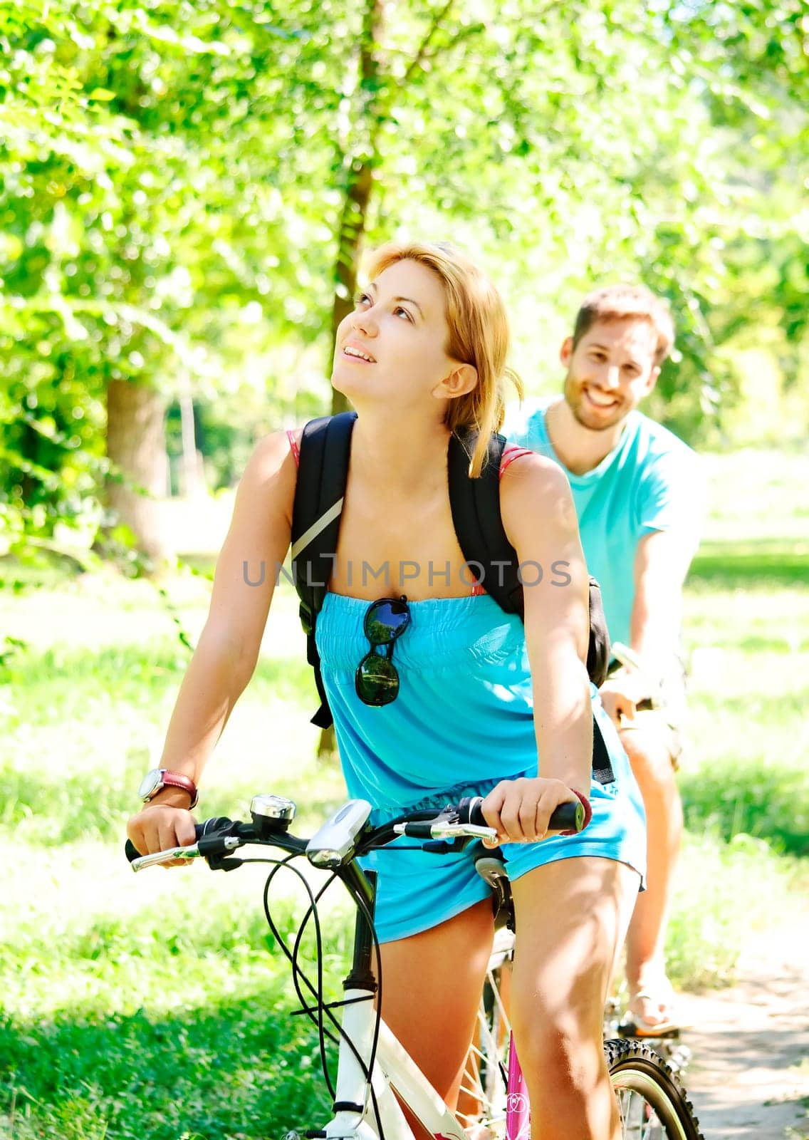 Young man and woman having a bike ride in nature