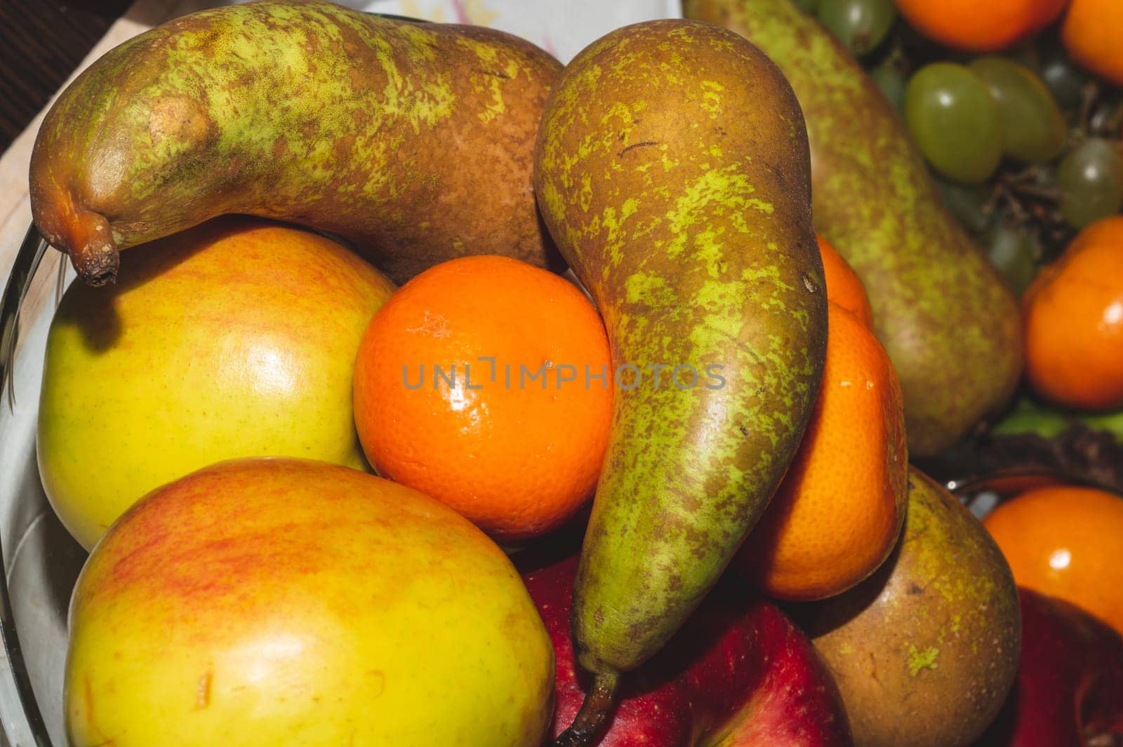 Ordinary fruit plate with natural looking fruits. fresh apples, pears and mandarins