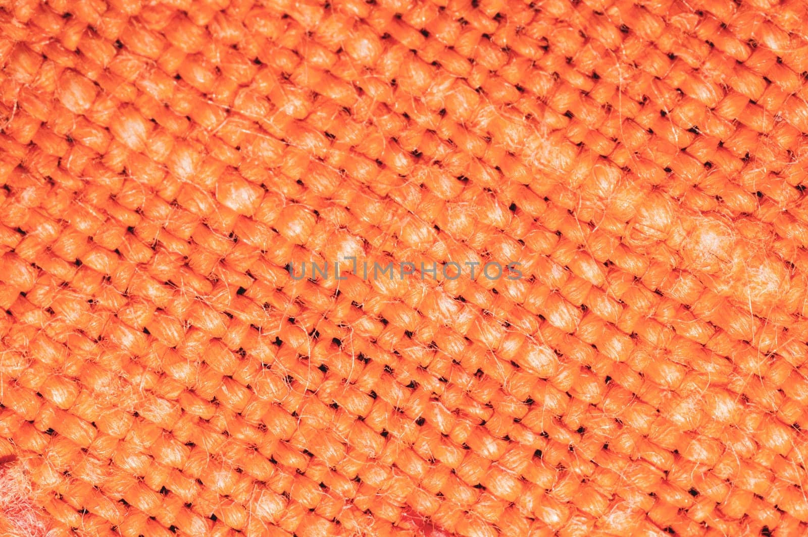 Orange fabric texture. knitted textile background. woven material close up