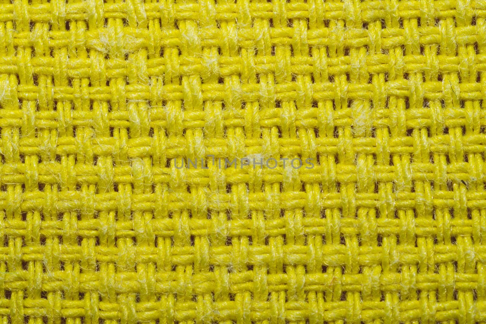 Yellow knitted fabric texture. woven material close up. textile background