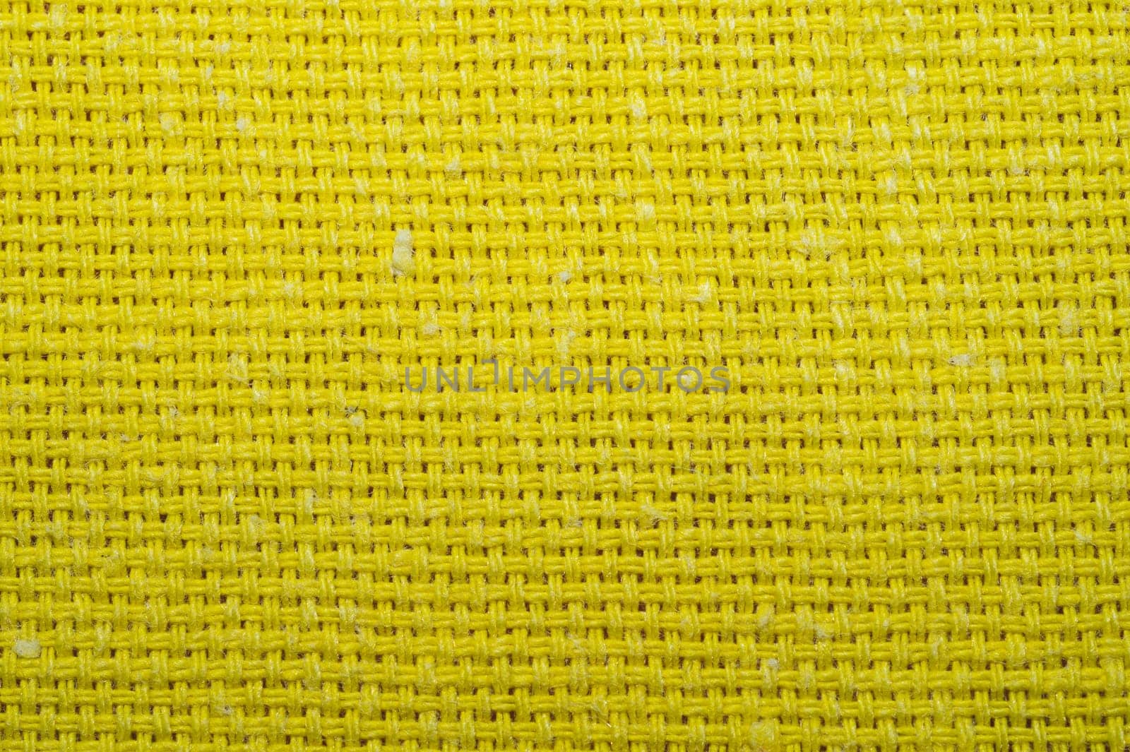 Yellow knitted fabric texture. woven material close up. textile background