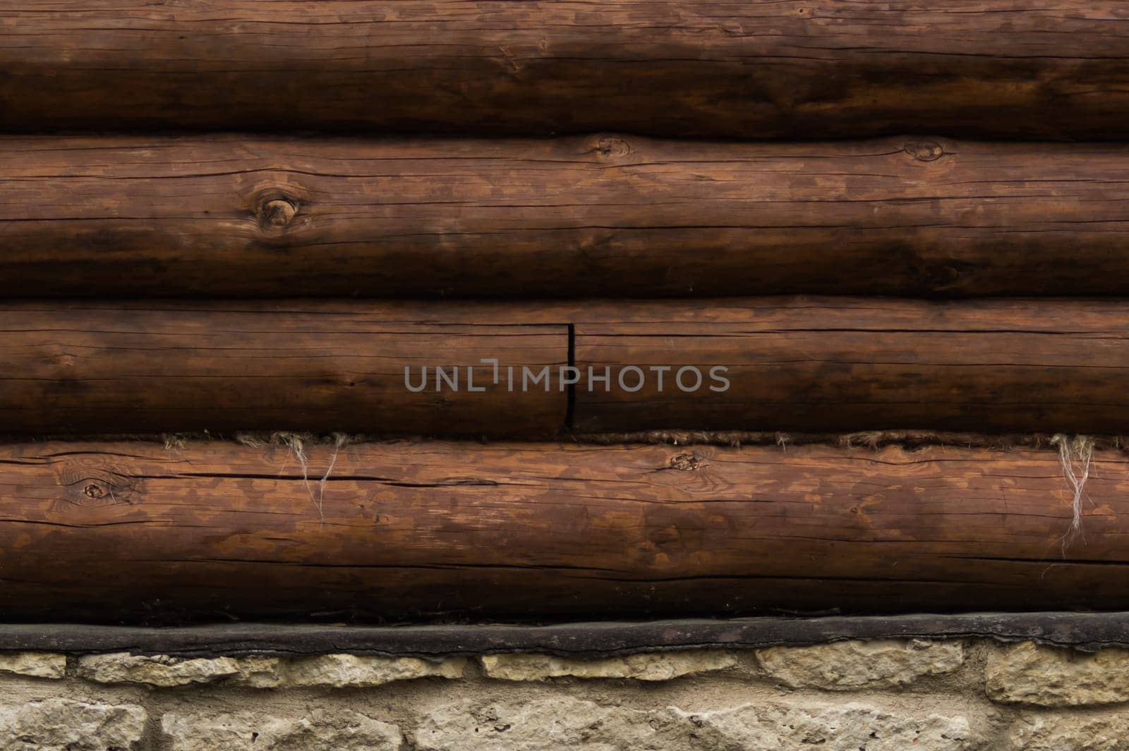Wall of logs. wood background. rural house exterior