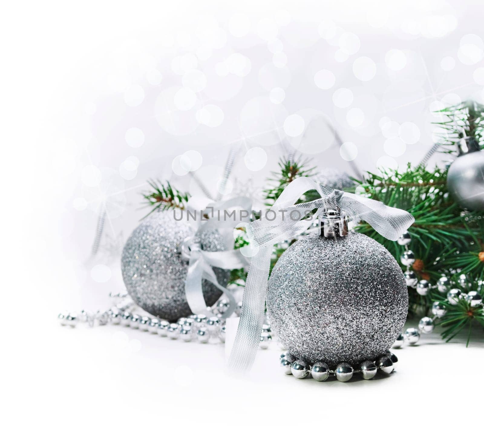 Silver christmas ornaments with bokeh background