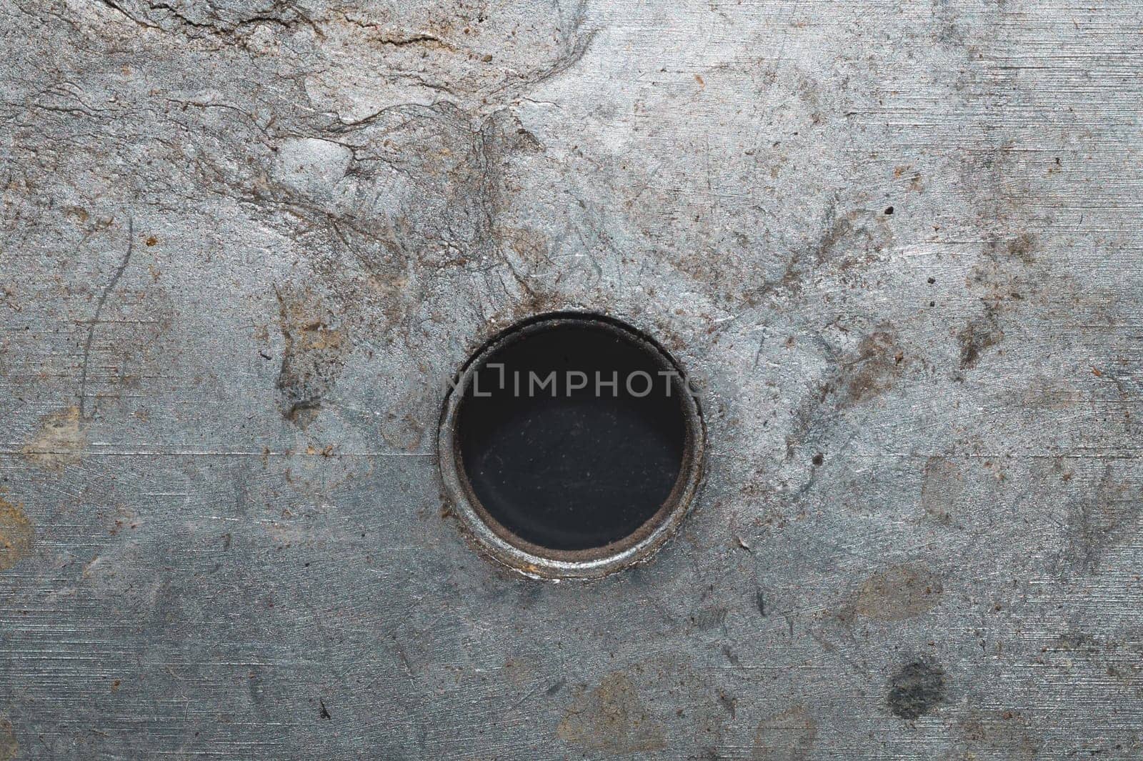 Iron plate macro. metal sheet with hole. steel background close up