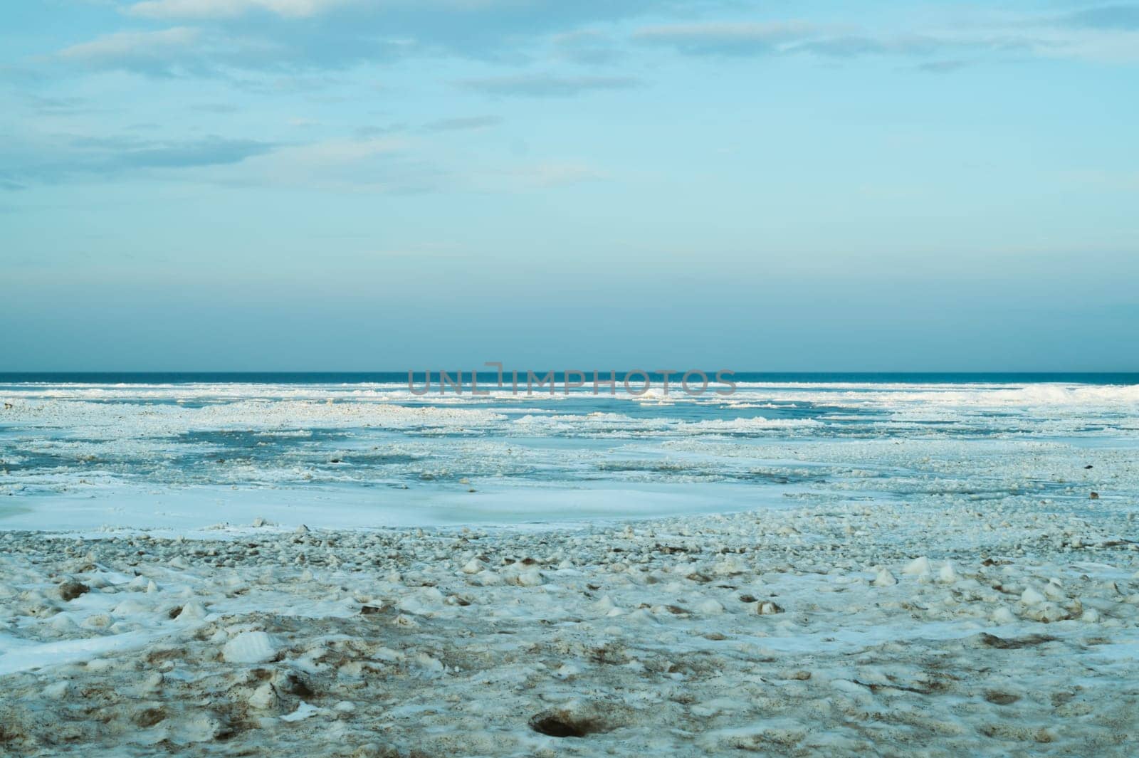Blue frozen lake with the sky. winter landscape. nature background with a horizon line