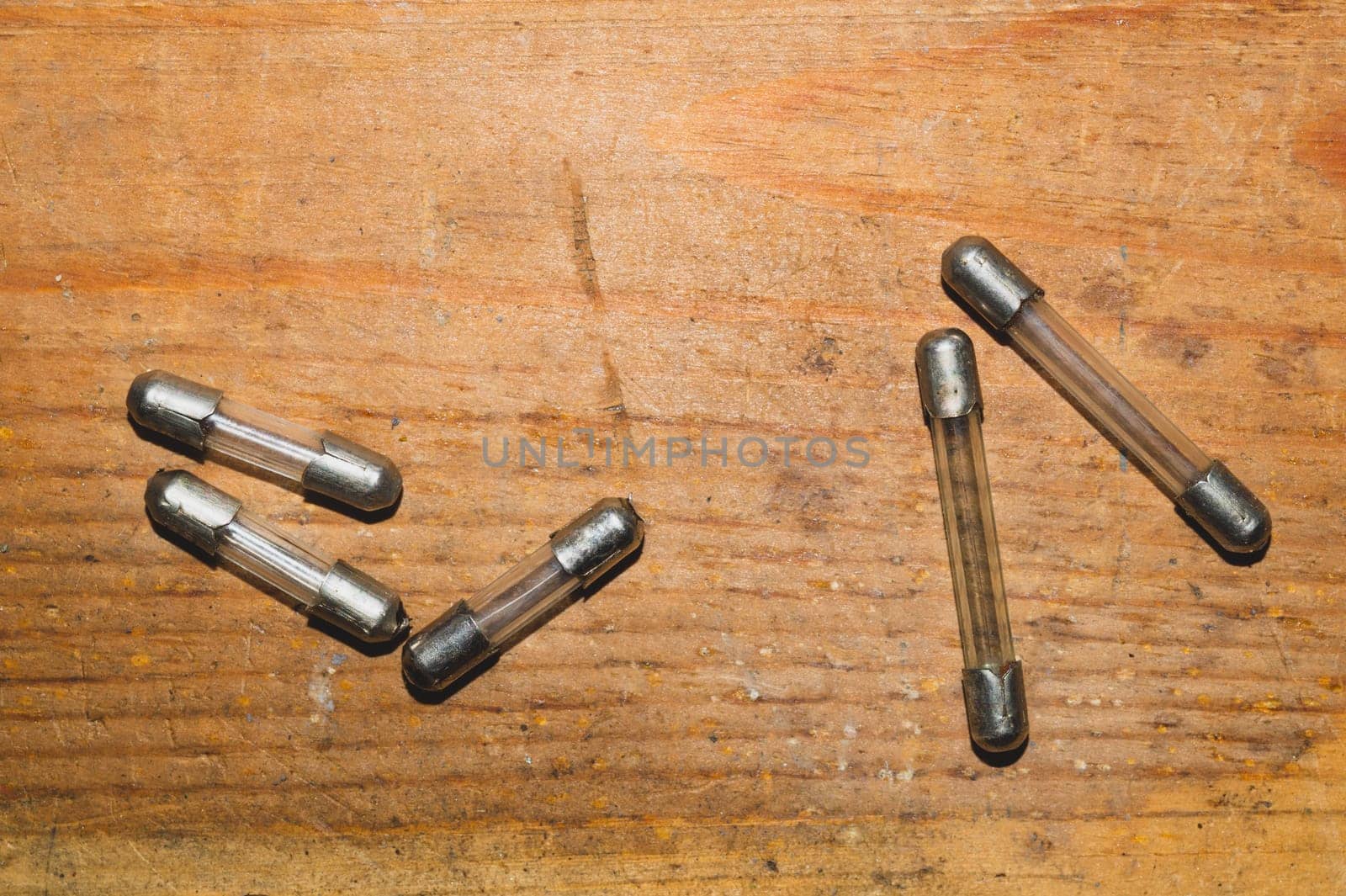 Fuse on wooden background. safety device for overcurrent protection. protection of an electrical circuit