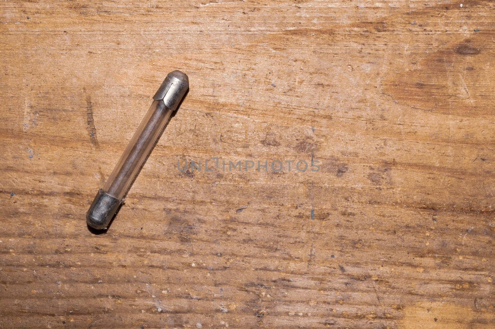 Fuse on wooden background. safety device for overcurrent protection. protection of an electrical circuit