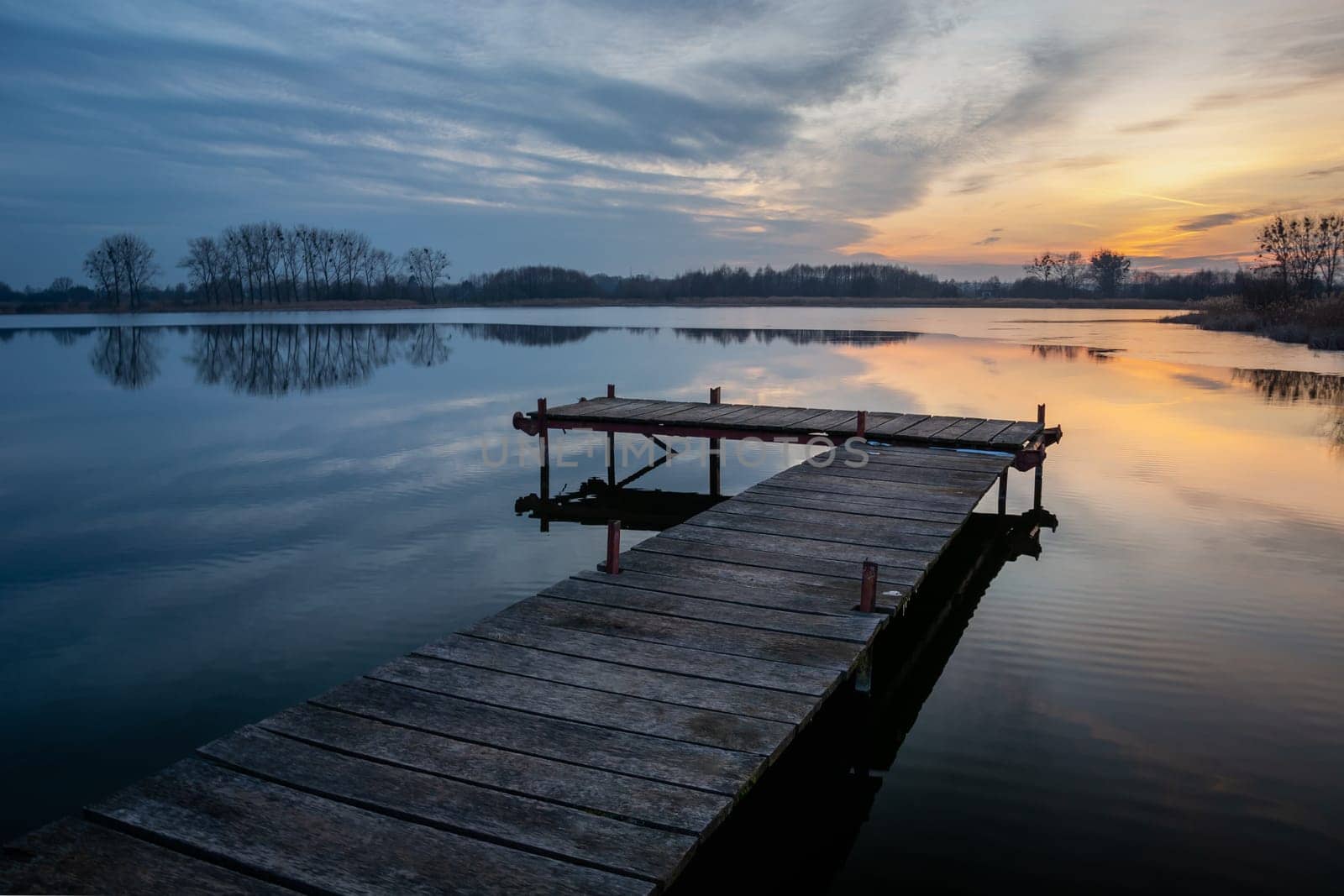 Wooden pier on a calm lake and evening clouds, Stankow, Lubelskie, Poland