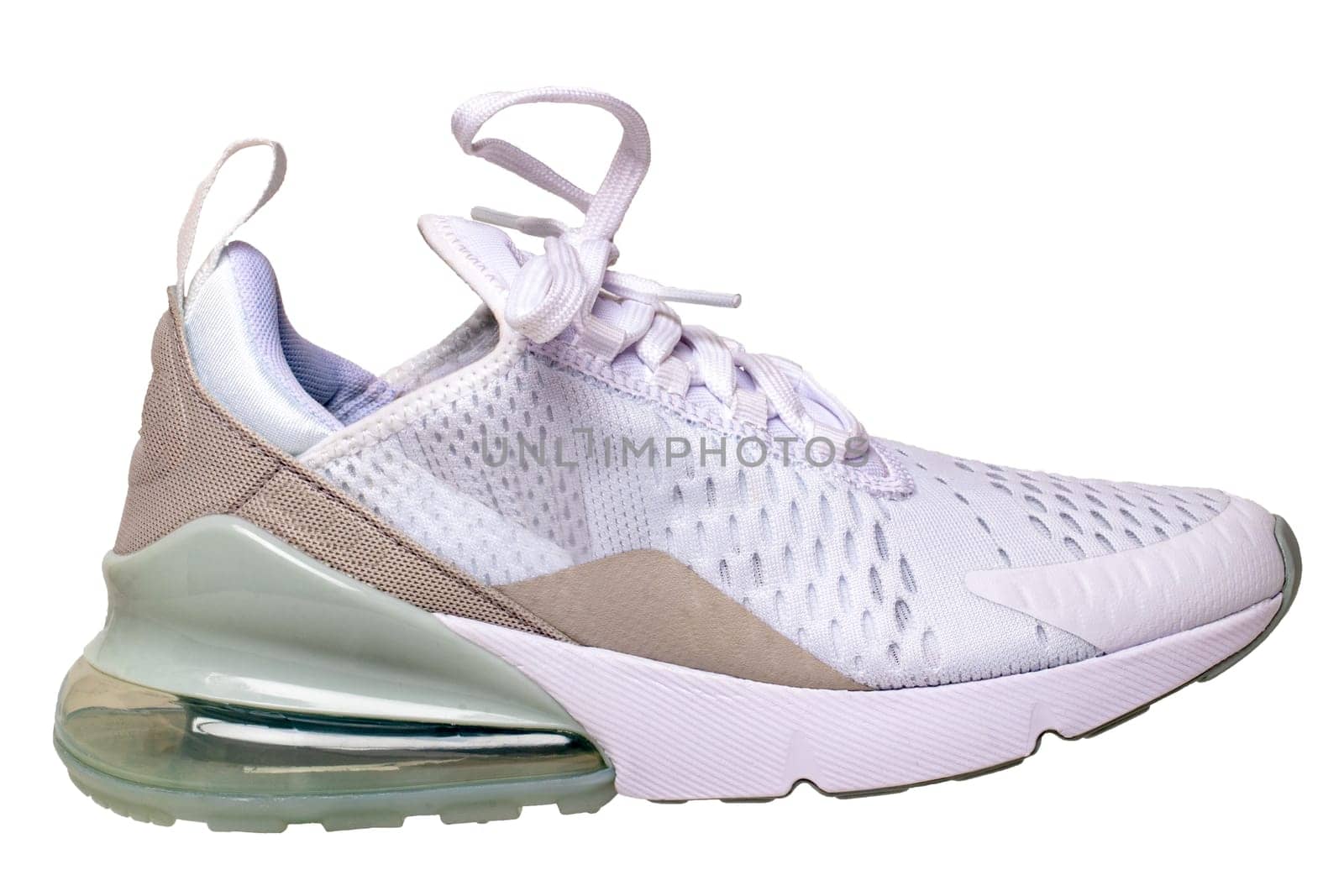 White sneaker isolated. Close-up of a single white elegant stylish female leather high-heeled sport shoes isolated on a white background. Womens shoe fashion. Modern design footwear for workout. Macro.