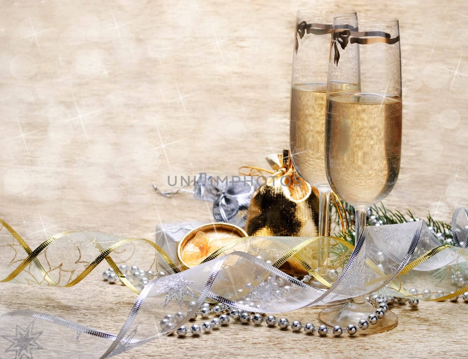 Two champagne glasses with presents and decorative ribbon