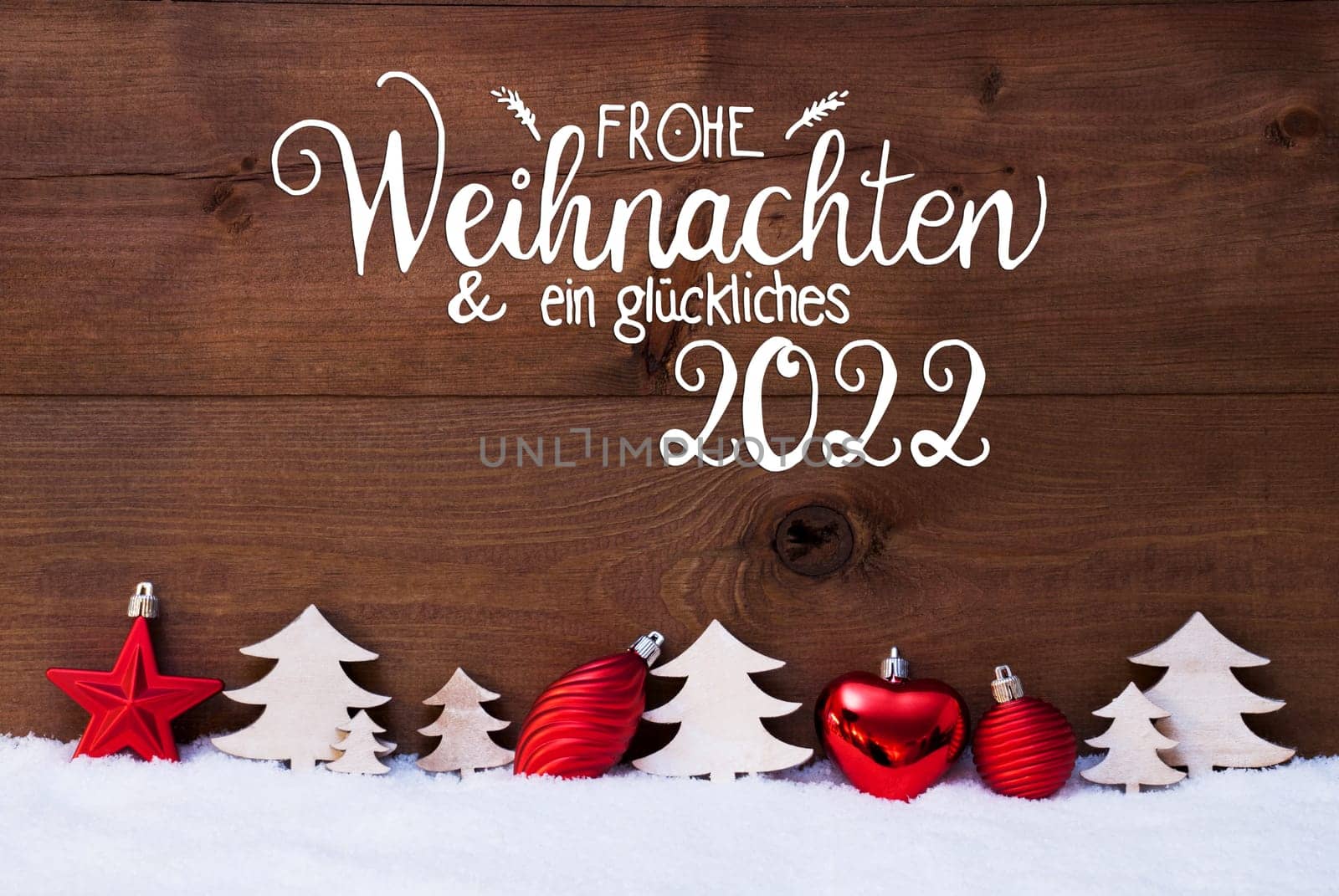 German Calligraphy Frohe Weihnachten Und Ein Glueckliches 2022 Means Merry Christmas And A Happy 2022. Red Christmas Decoration Like Tree And Ball Ornament. Wooden Background With Snow