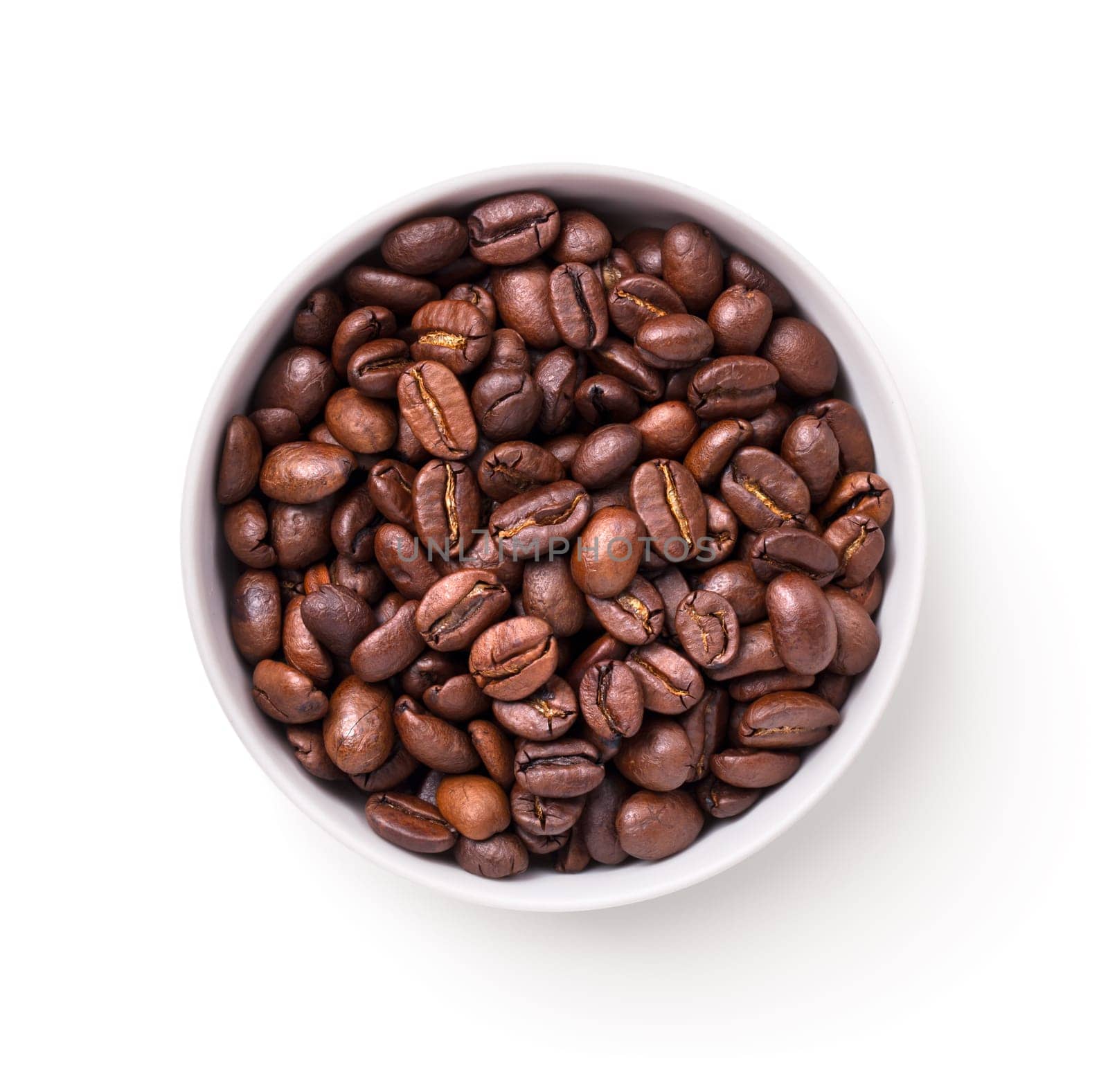 Coffee beans in white bowl isolated over white background. Top view