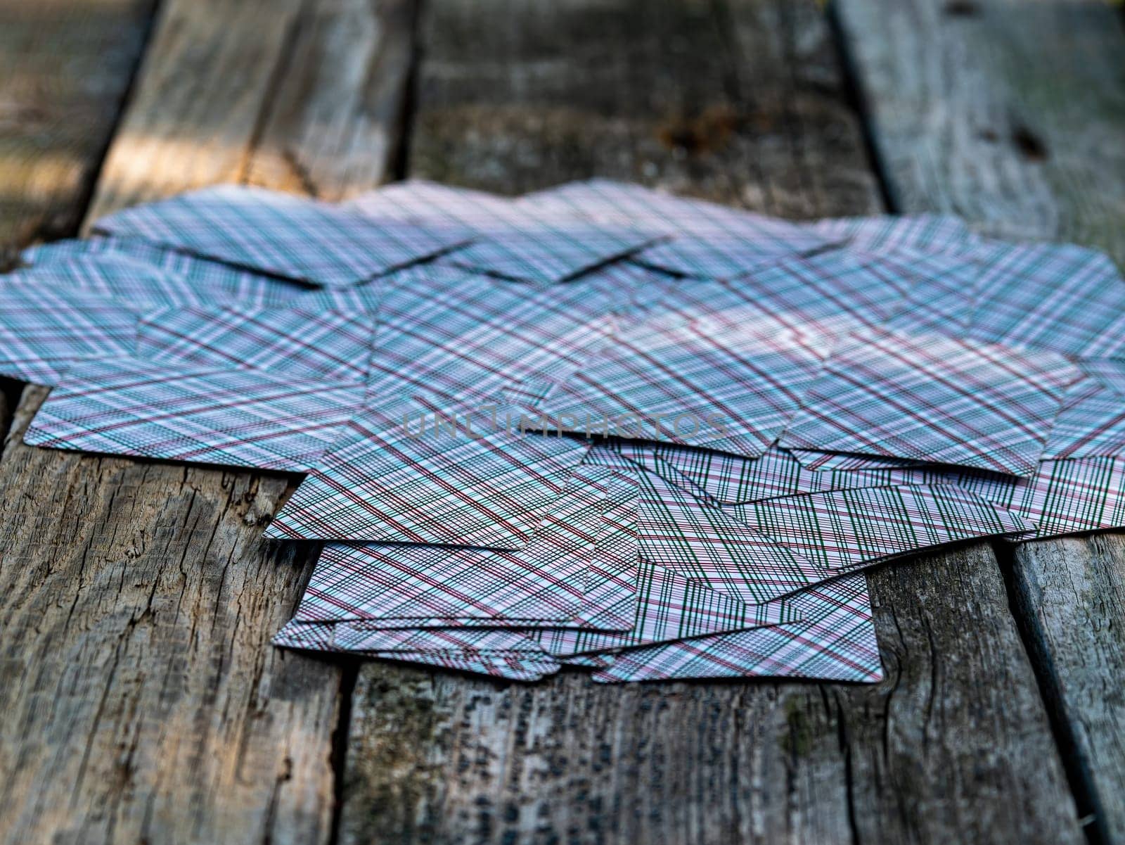 A deck of playing cards on a wooden table. A deck of playing cards. Gambling. Summer rest. Background image. Game table. Place for your text.