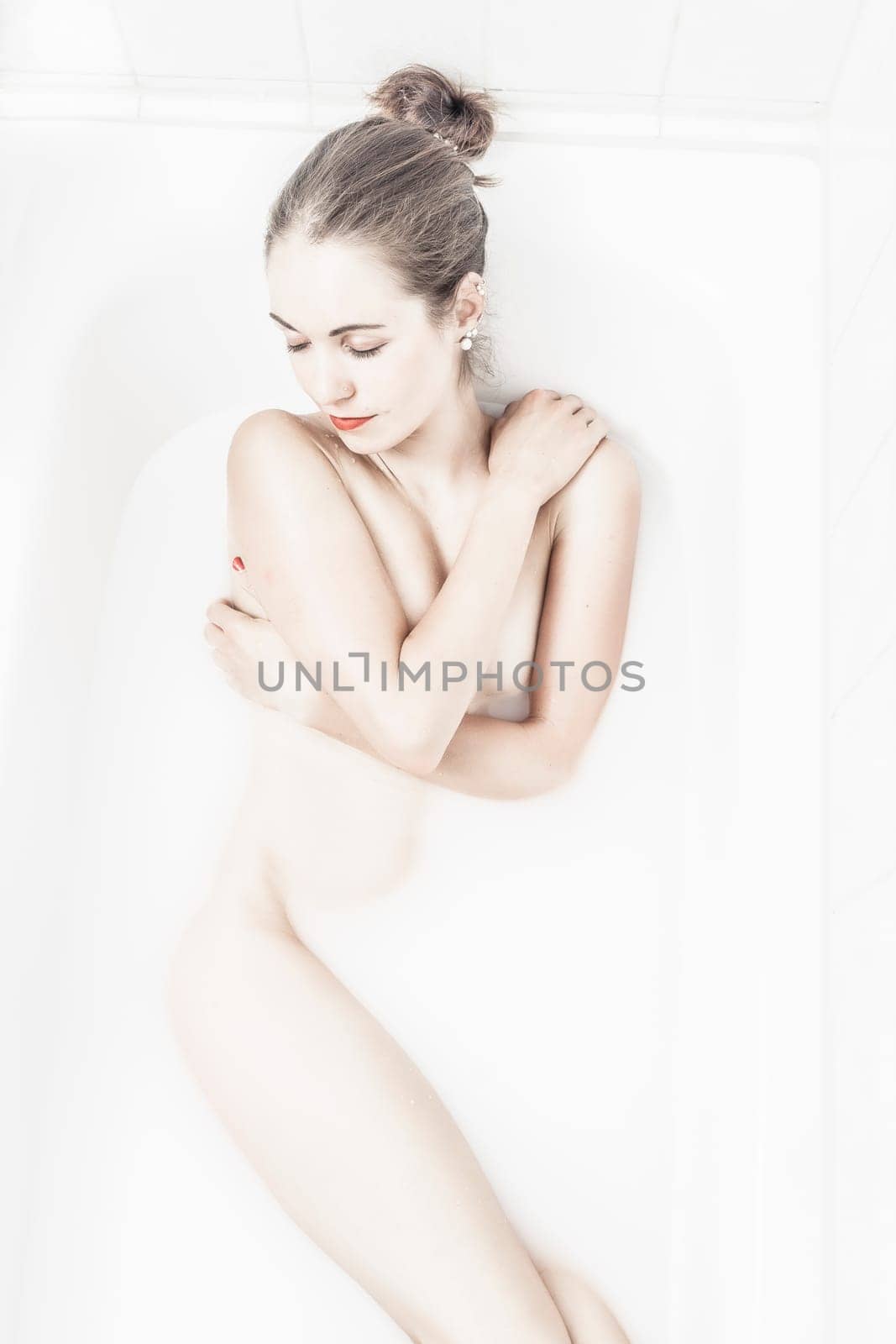 young woman in the bathtub at wellness