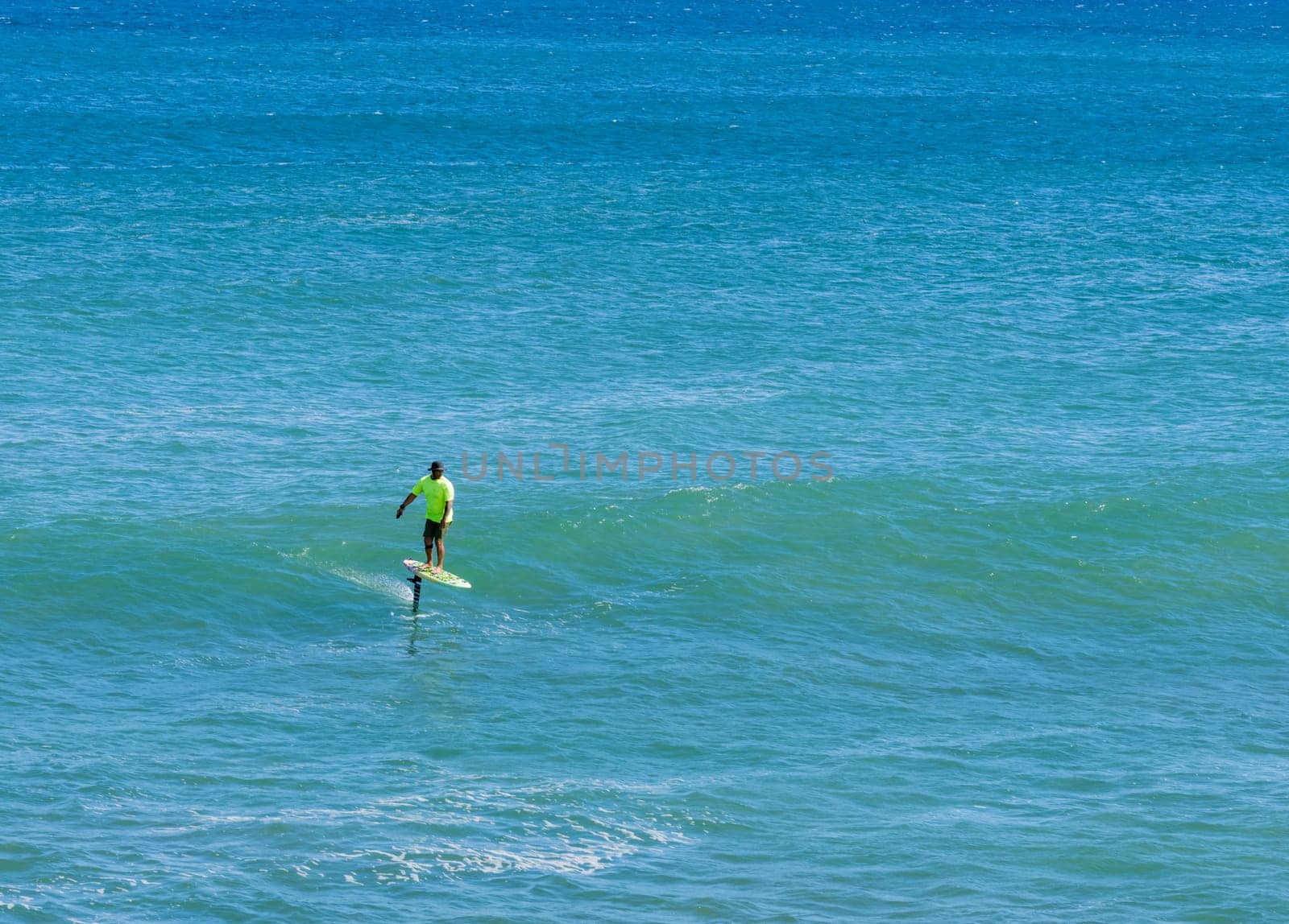 Anahola, Kauai - 1 February 2025: A hydrofoil surfer enjoys the waves at Anahola Beach Park, Kauai, Hawaii