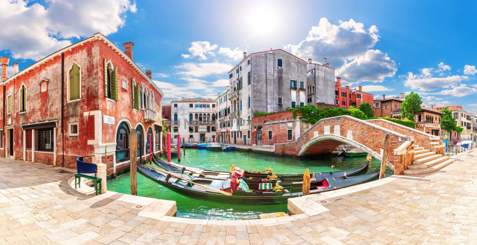 Gondolas moored in the Grand Canal by the bridge, Venice, Italy.