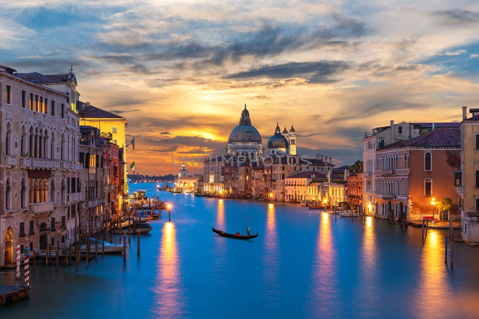 Grand Canal of Venice with a lonely gandolier at sunset, Italy.