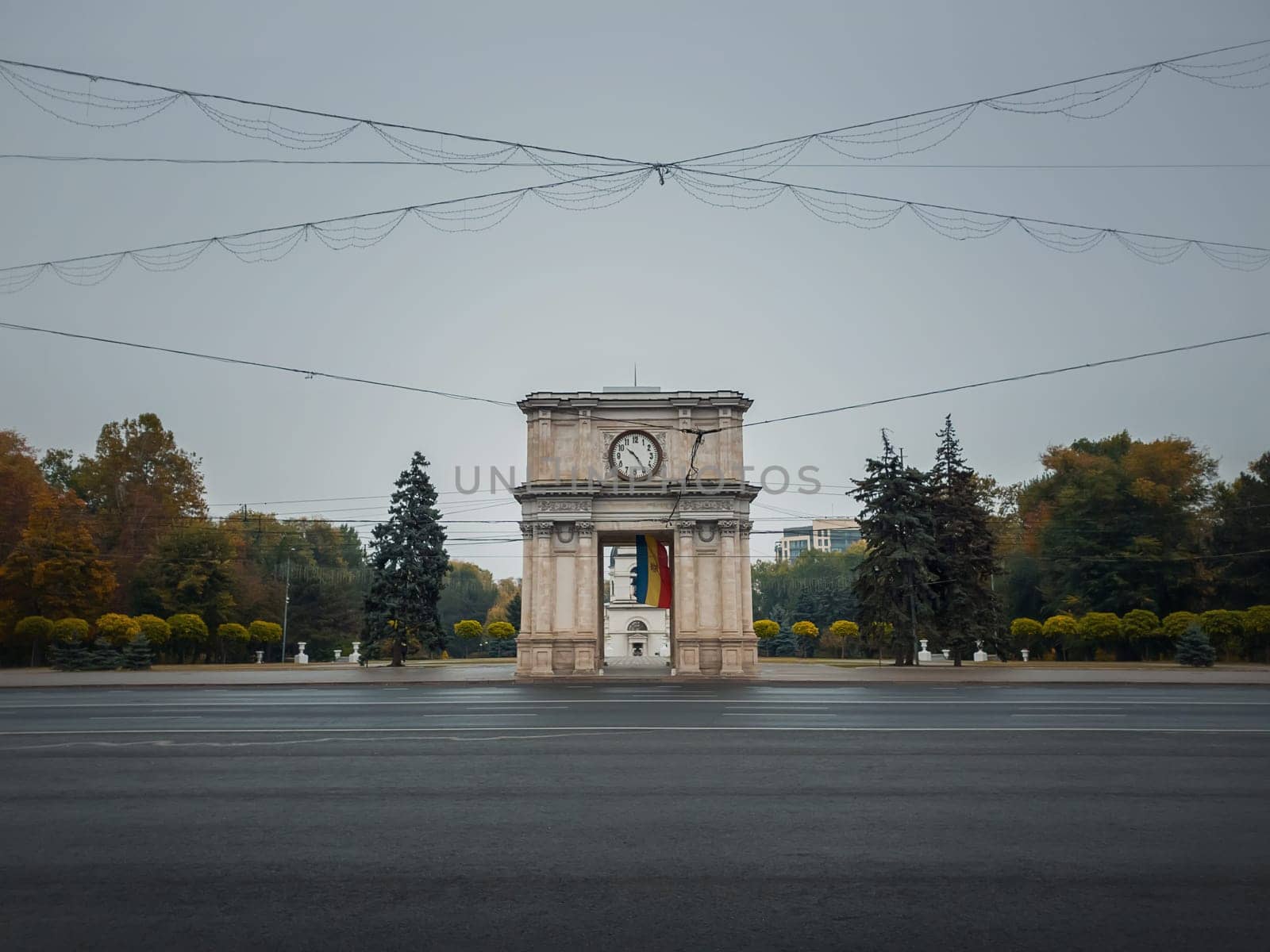 Triumphal Arch in Chisinau city, Moldova. Autumn season view from the street to the landmark in a rainy day..