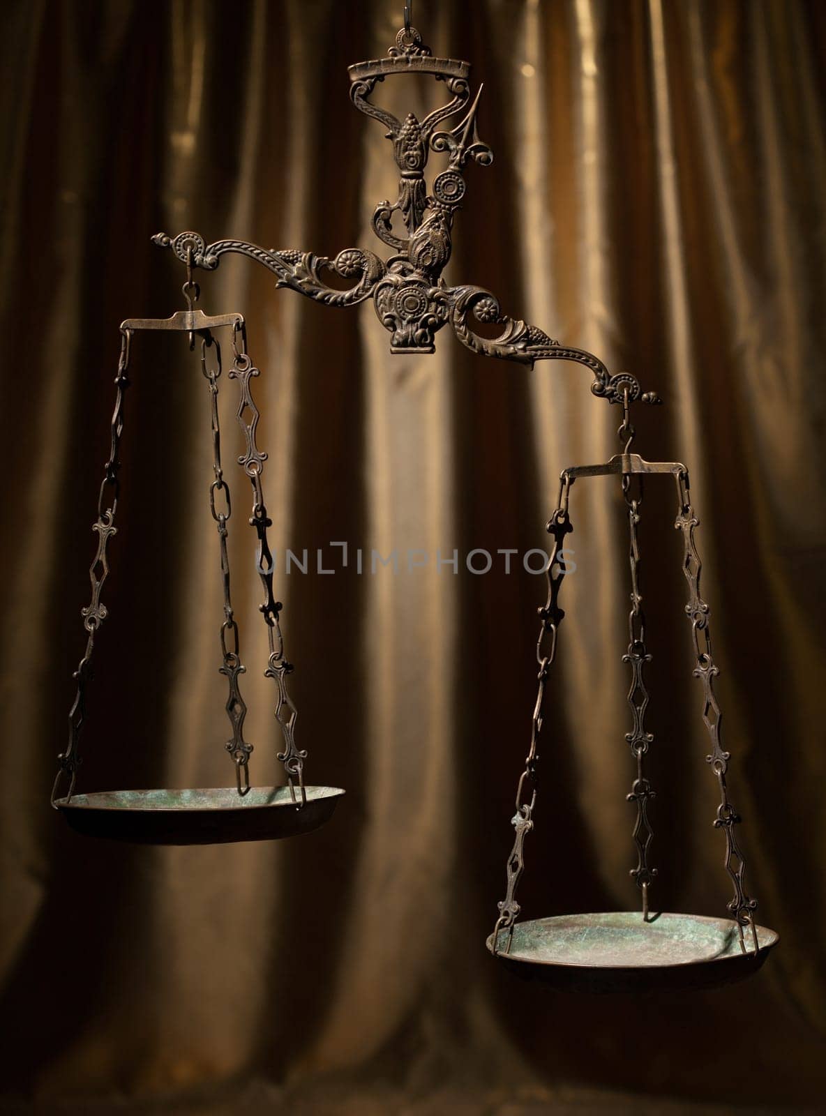 Antique rusty weighing scale on golden background.