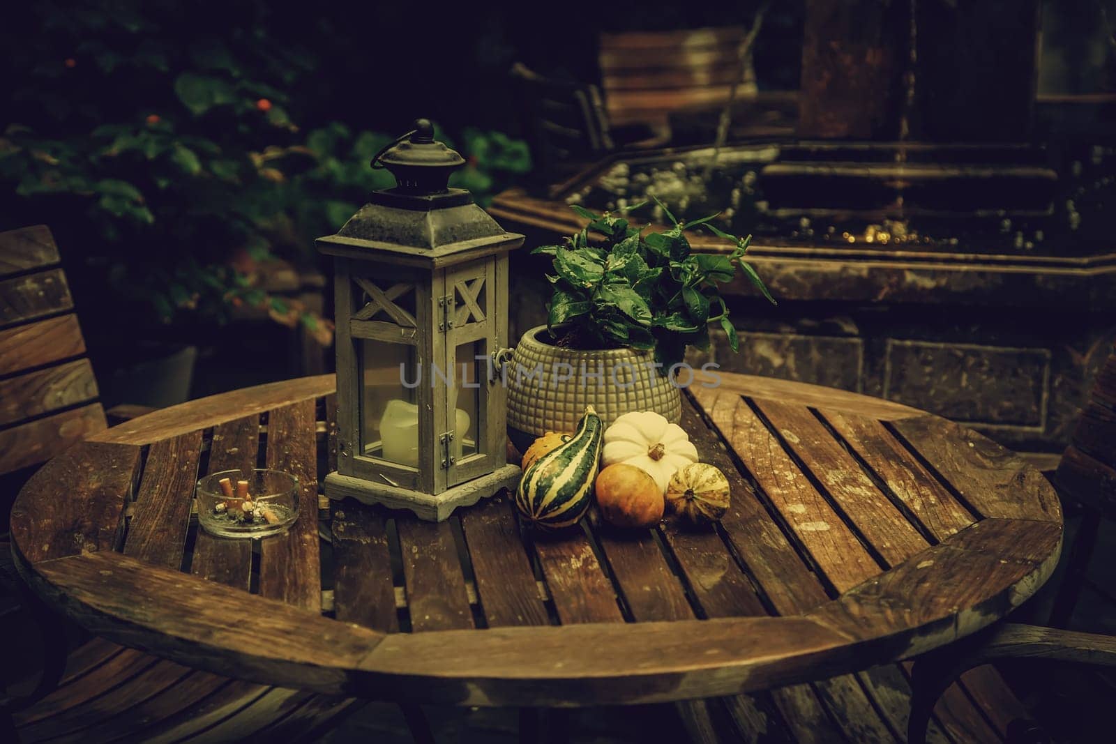 Garden table with pumpkins, decorated terrace detail of halloween