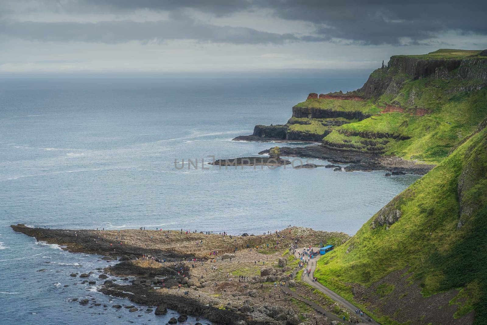 Crowds of tourists visiting Giants Causeway, seen from top of the cliff, Wild Atlantic Way and UNESCO world heritage, located in Northern Ireland