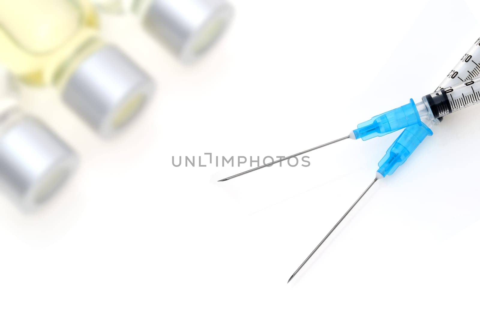 medical disposable syringe with vaccine bottle on white background