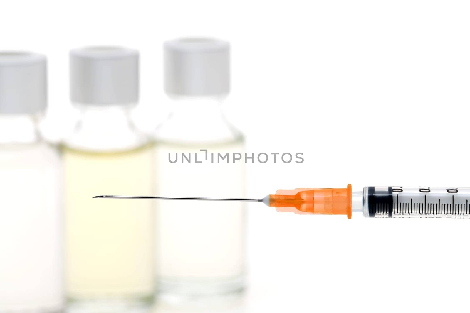 medical disposable syringe with vaccine bottle on white background