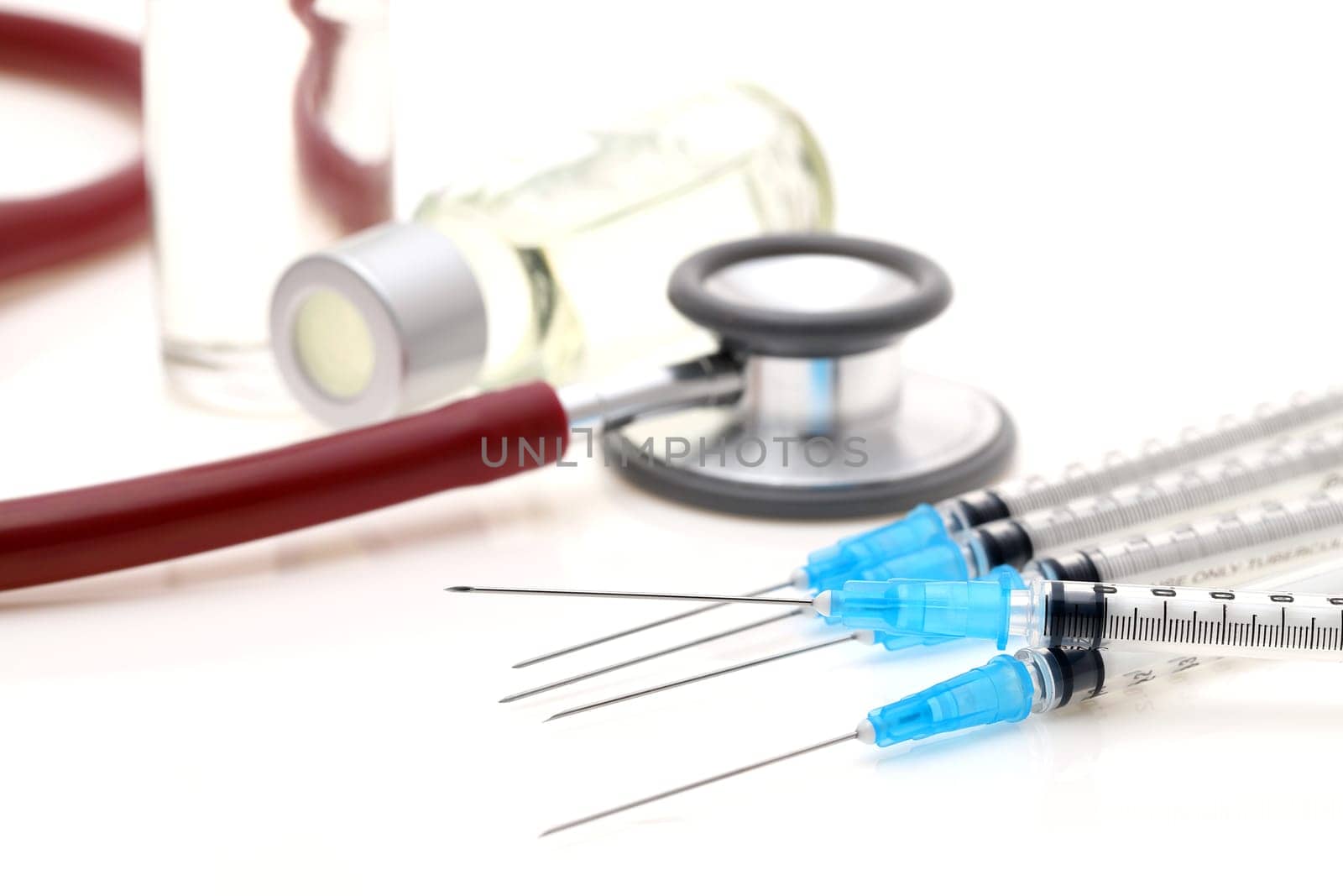 medical disposable syringe with vaccine bottle on white background