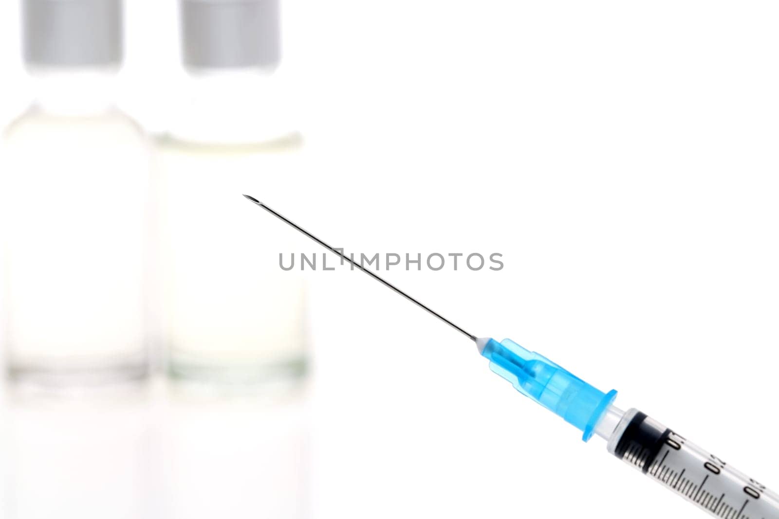 medical disposable syringe with vaccine bottle on white background