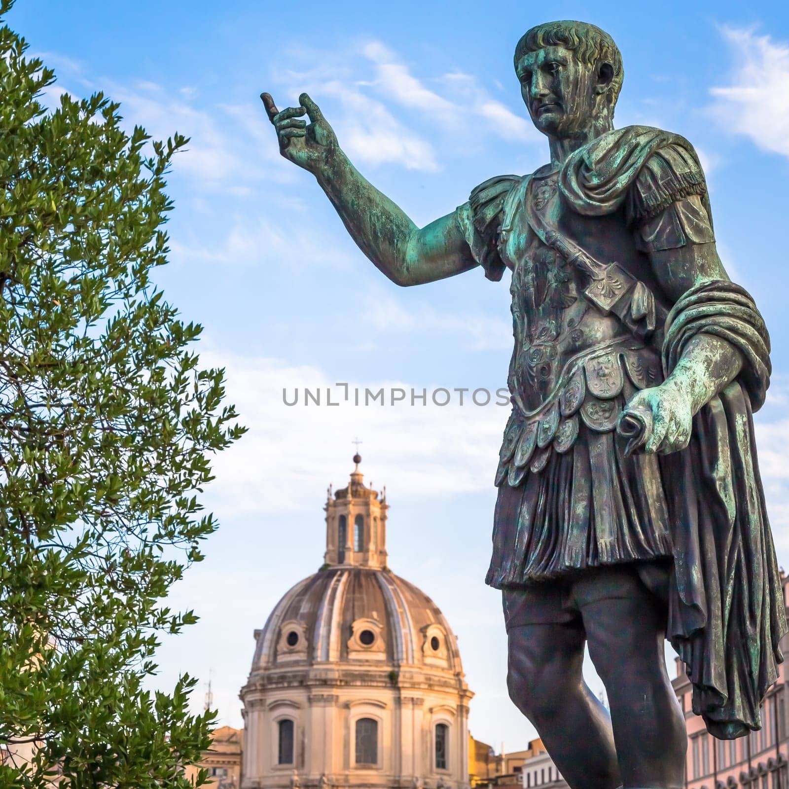 ITALY, ROME - CIRCA AUGUST 2020: Statue of Caesar Emperor, made of bronze. Natural sunrise light. Ancient  role model of Leadeship and Authority .
