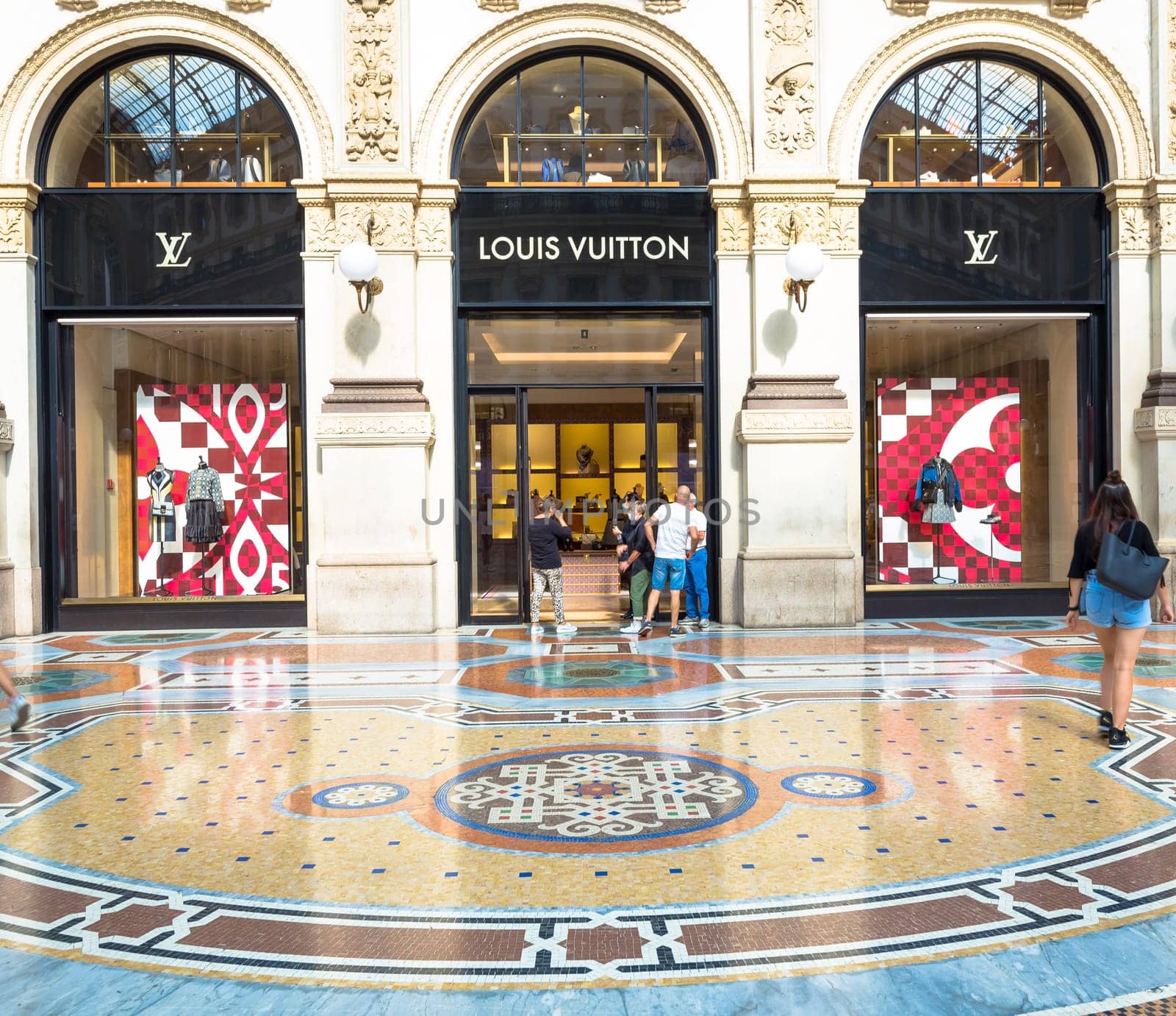 MILAN, ITALY - CIRCA SEPTEMBER 2020: Fashion shopping in Vittorio Emanuale's Gallery. People walking in front of a famous luxury boutique.