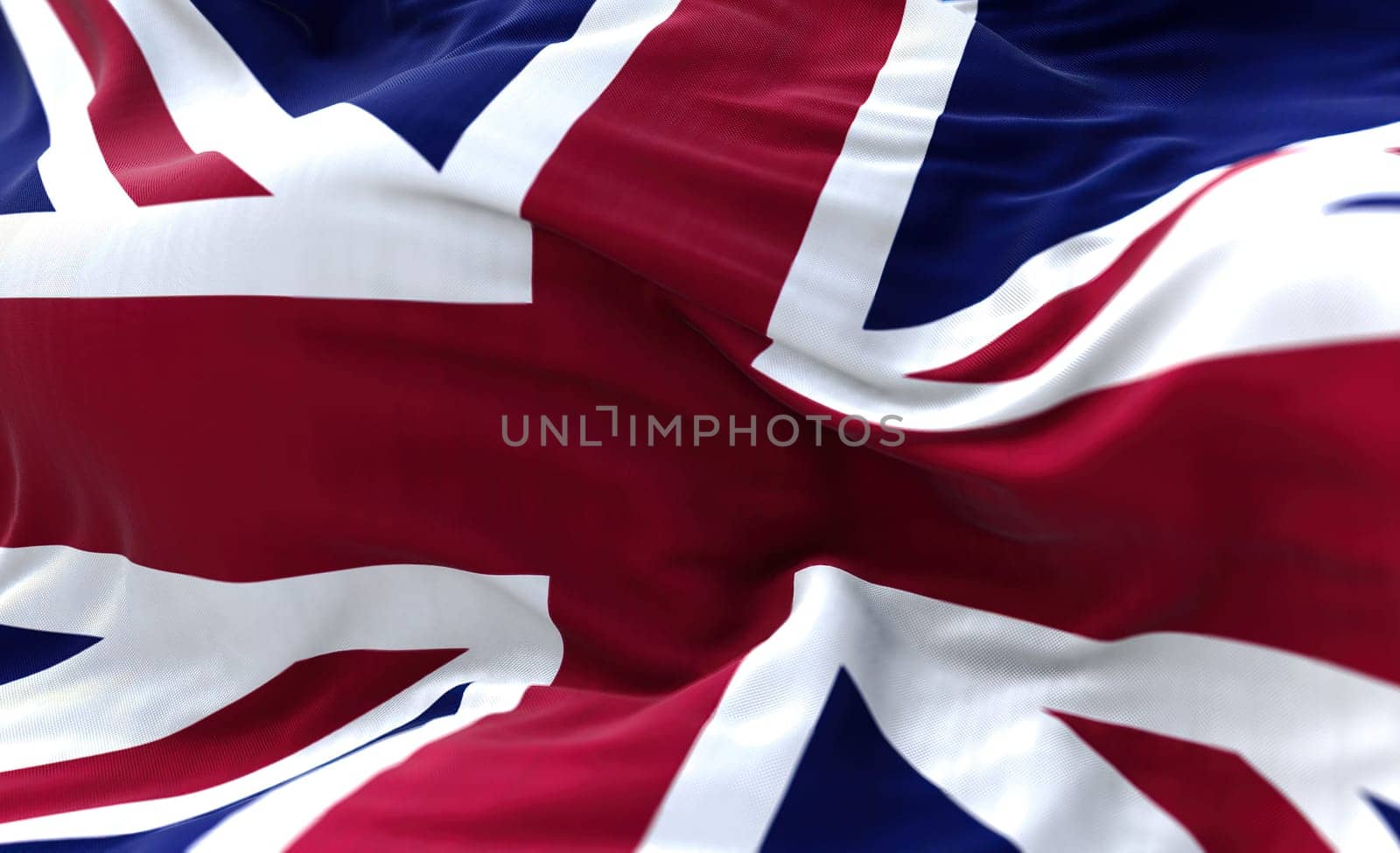 The national flag of the United Kingdom flying in the wind. Outdoors and sky in the background.
