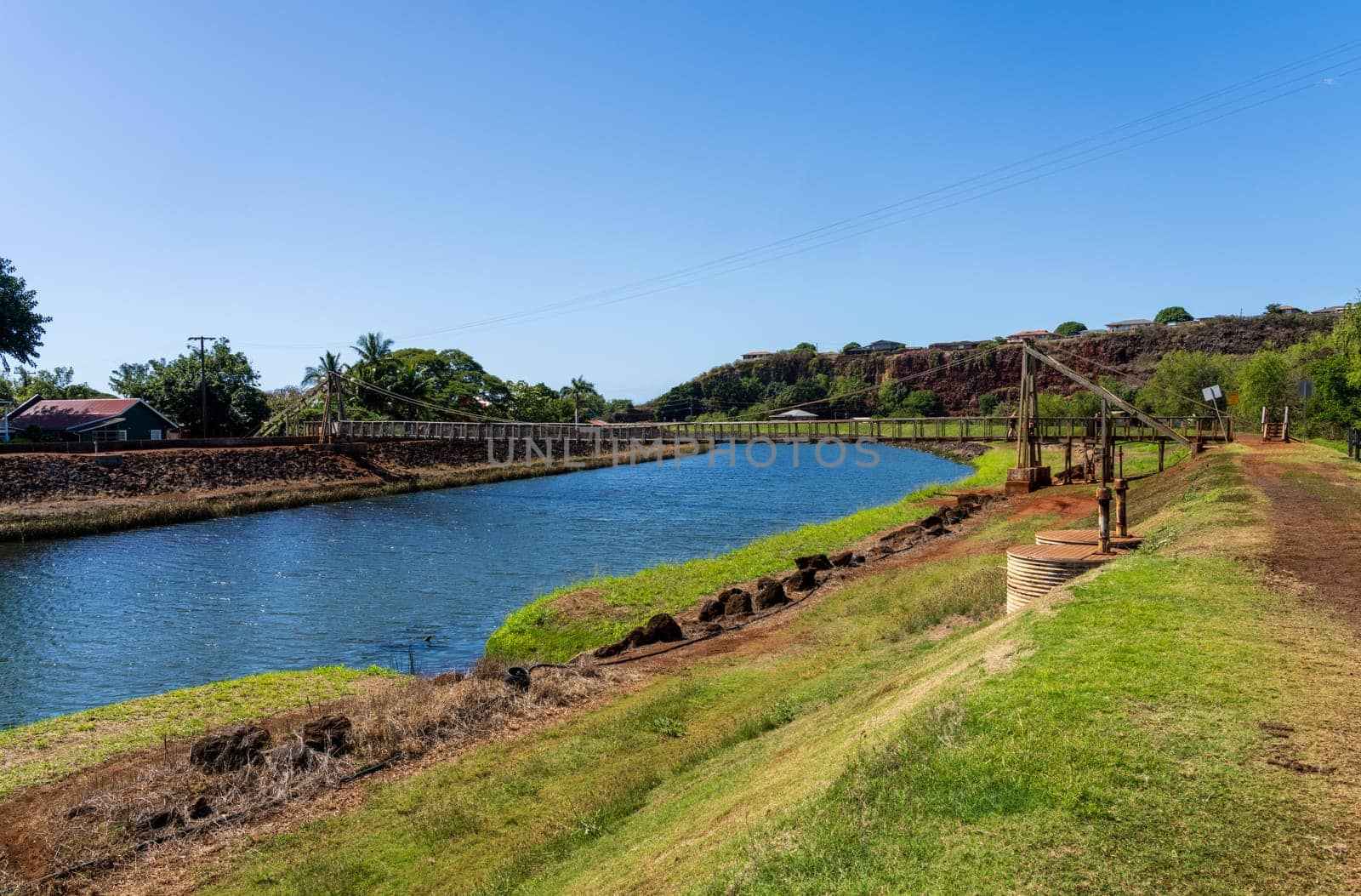 Panoramic view of the historic wooden swinging bridge across the river in Hanapepe, Kauai