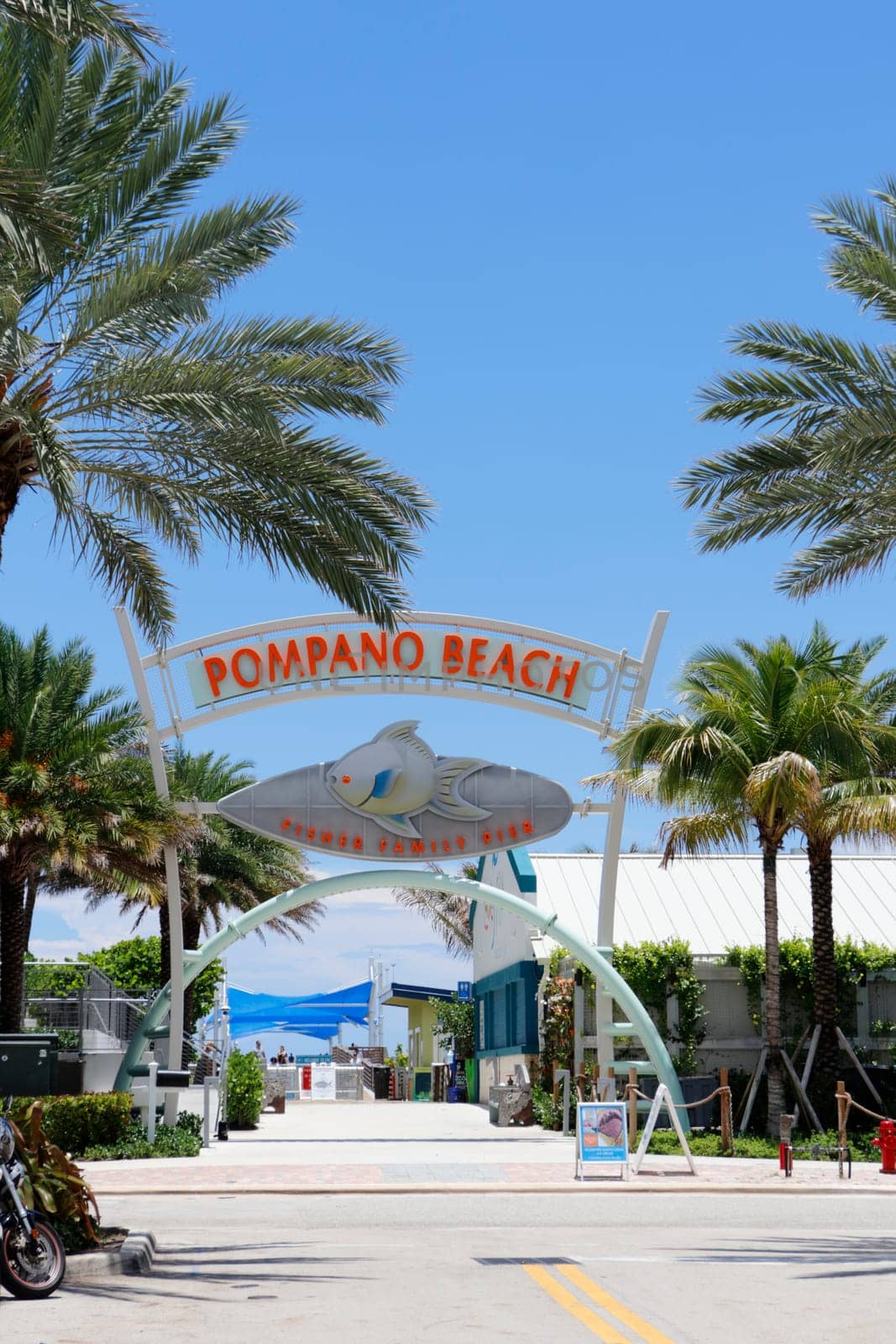Pompano Beach, FL, USA - July 2, 2021: Pompano Beach, Florida Fisher family pier sign in the day. Large walkway entrance sign to Pompano Beach, Florida Fisher family pier with a big pompano fish