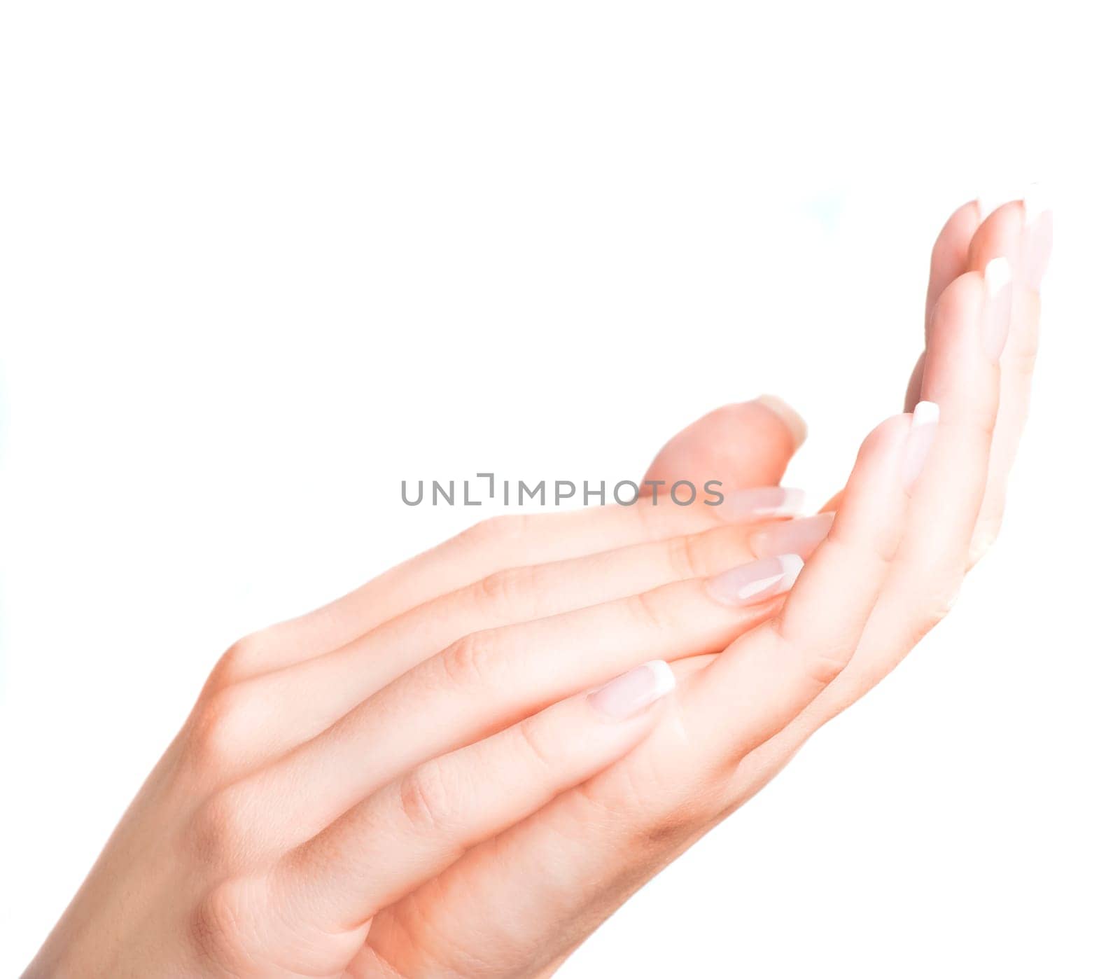 Beautiful female hands with french manicure isolated over white