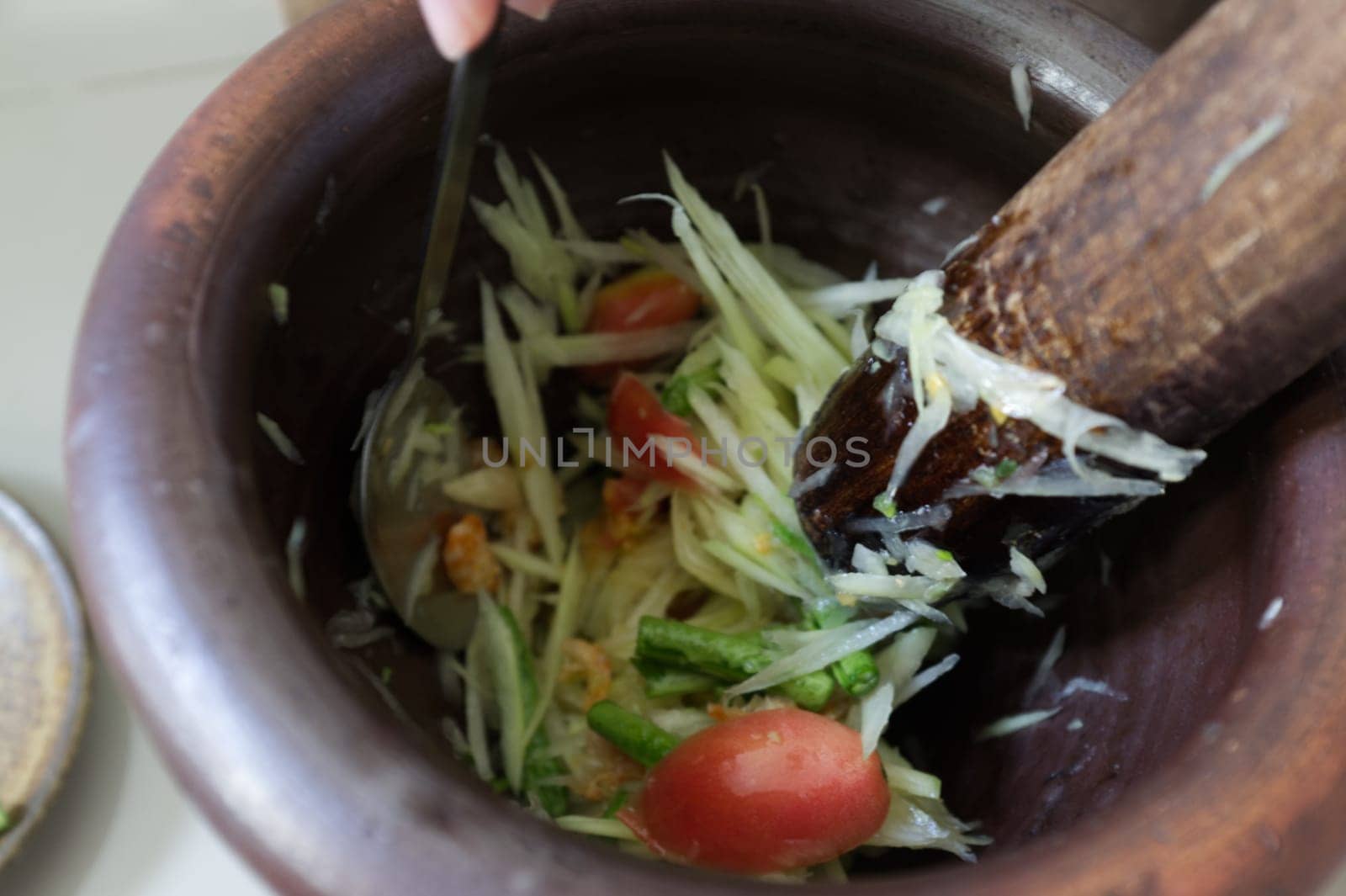 Motion Blur background , Som tum, making papaya salad in a mortar