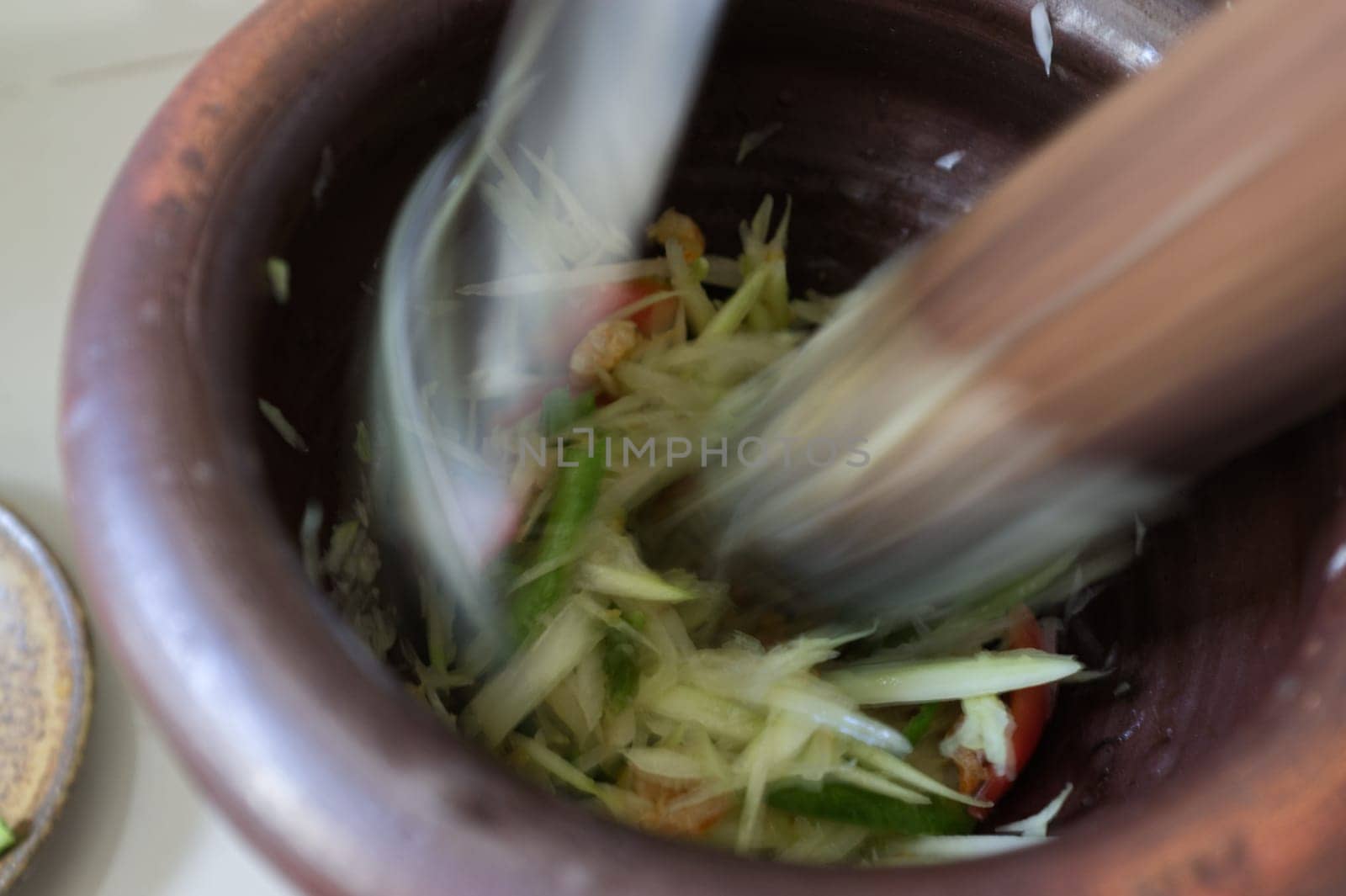 Motion Blur background , Som tum, making papaya salad in a mortar