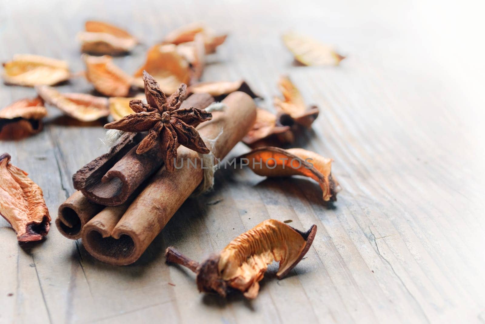 Cinnamon and anise seed on wooden plank