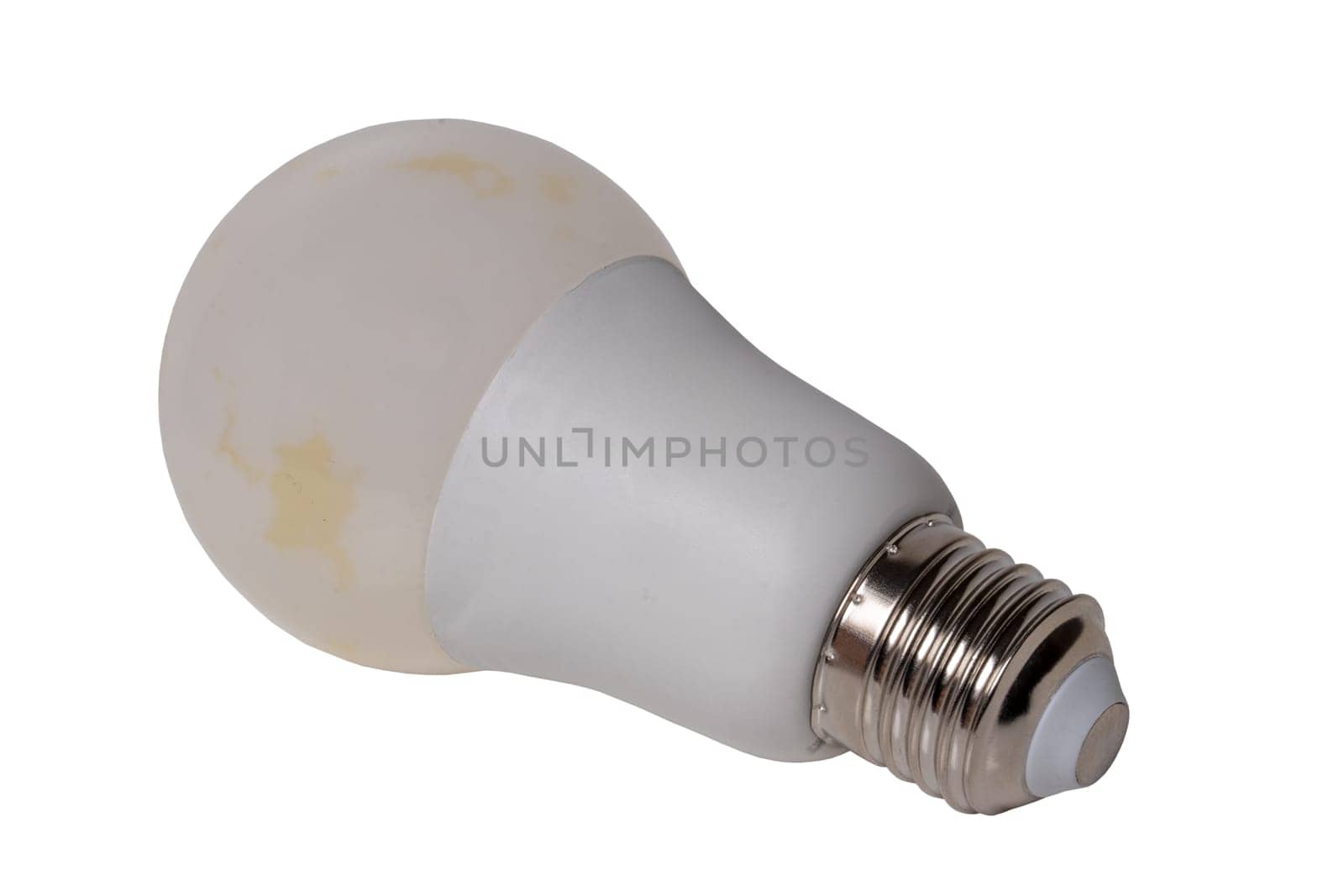 Close up of single defective white energy saving lamp or LED bulb isolated on white background. Clipping path. Macro.