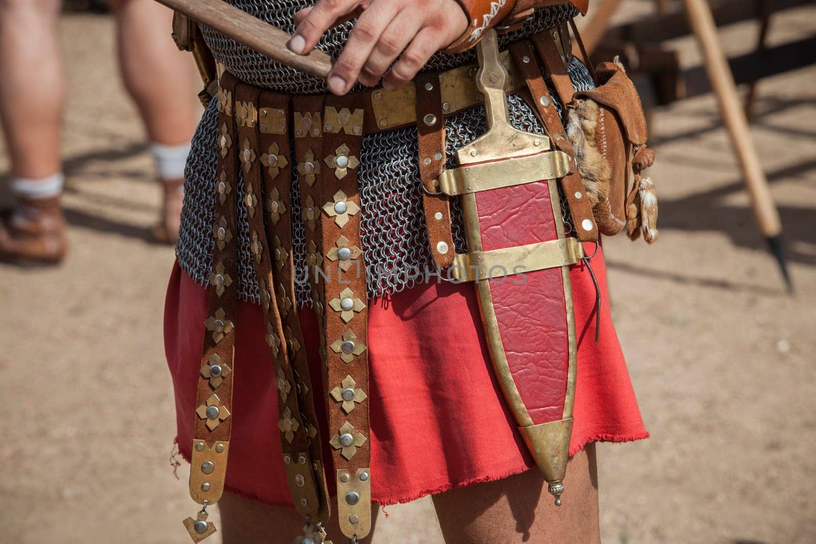 Centurion girding a pugio, a dagger used by roman soldiers as a sidearm. Historical reenactment