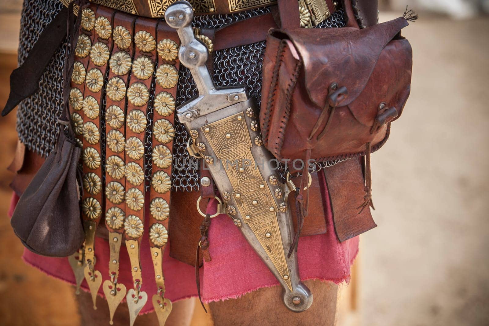 Centurion girding a pugio, a dagger used by roman soldiers as a sidearm. Historical reenactment