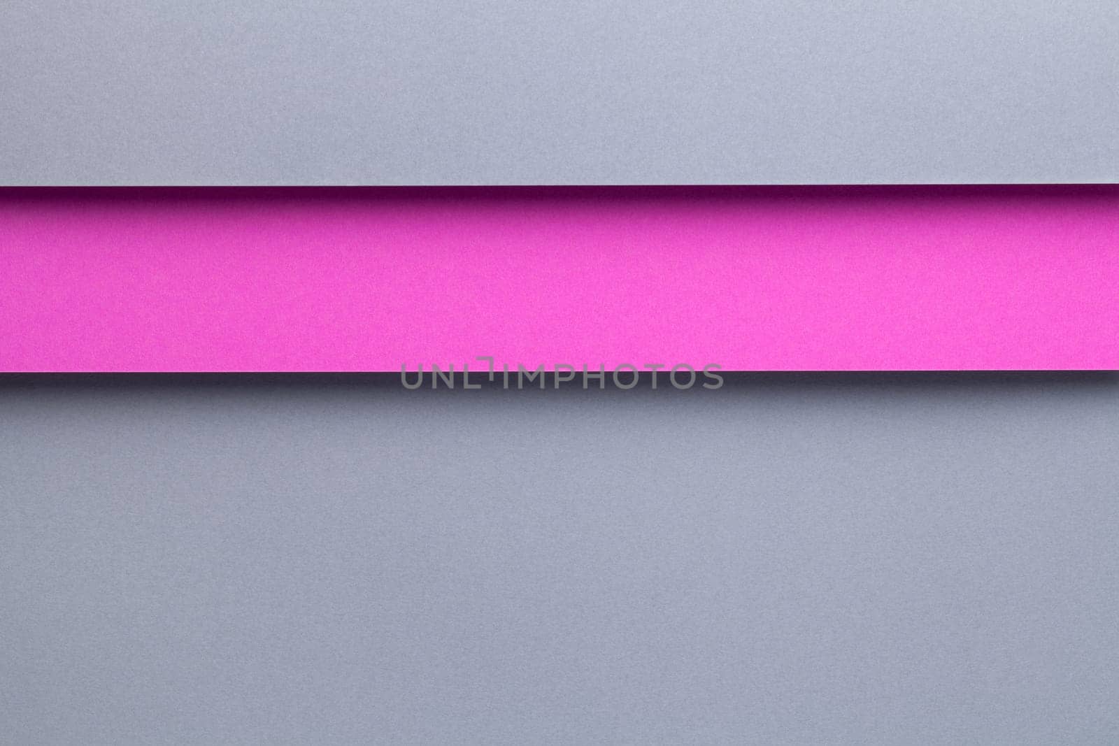 Abstract geometric composition background with gray and pink paper layers. Top view, flat lay